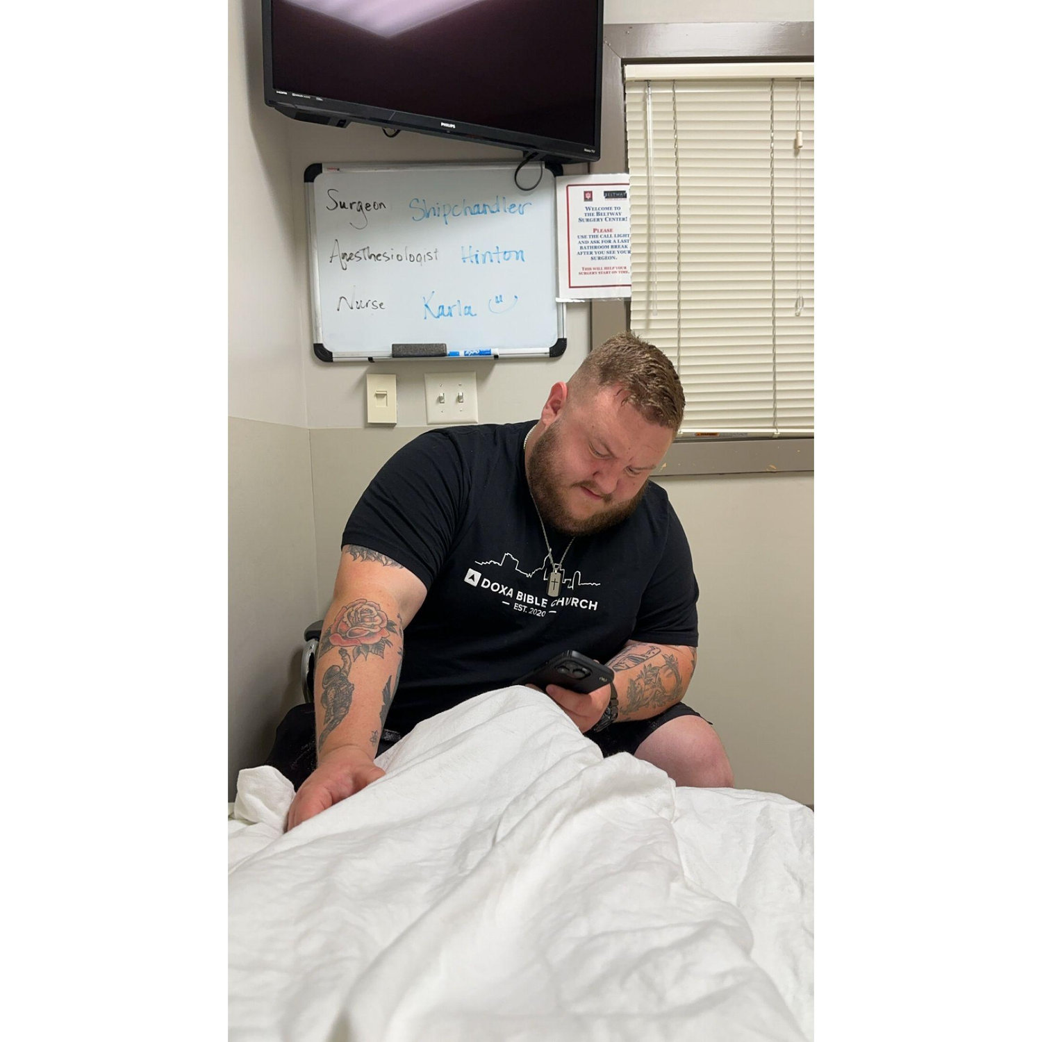 Austin sitting at the end of my bed in the pre-op room.