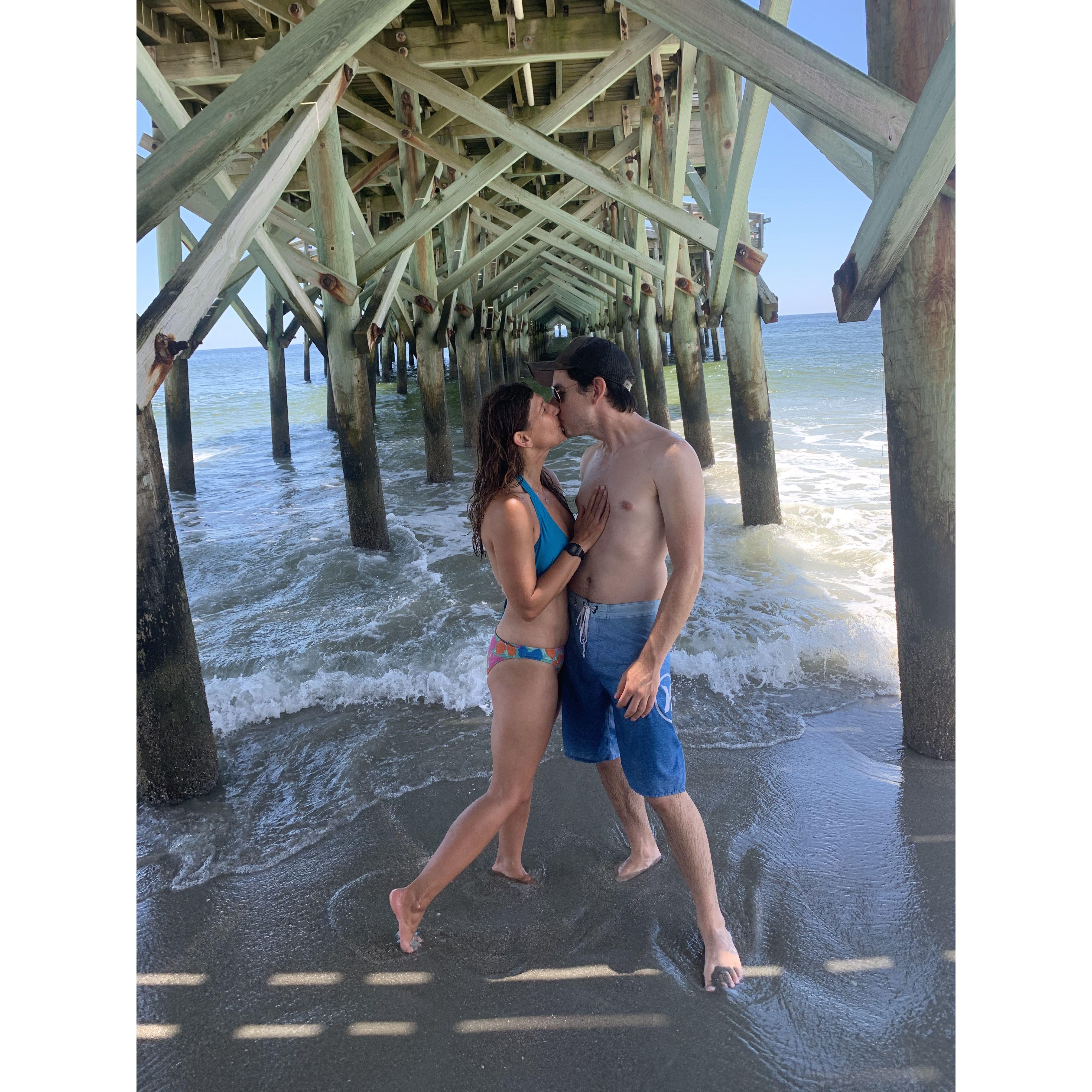 Stealing a kiss under the pier in Myrtle Beach