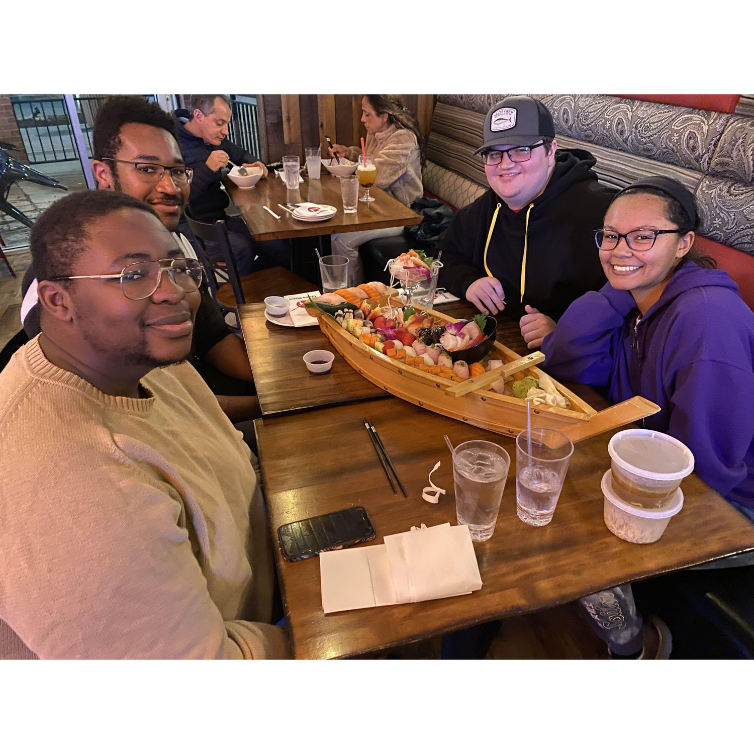 Taking on the sushi boat with Julian, best man and Isaiah, a Groomsmaid