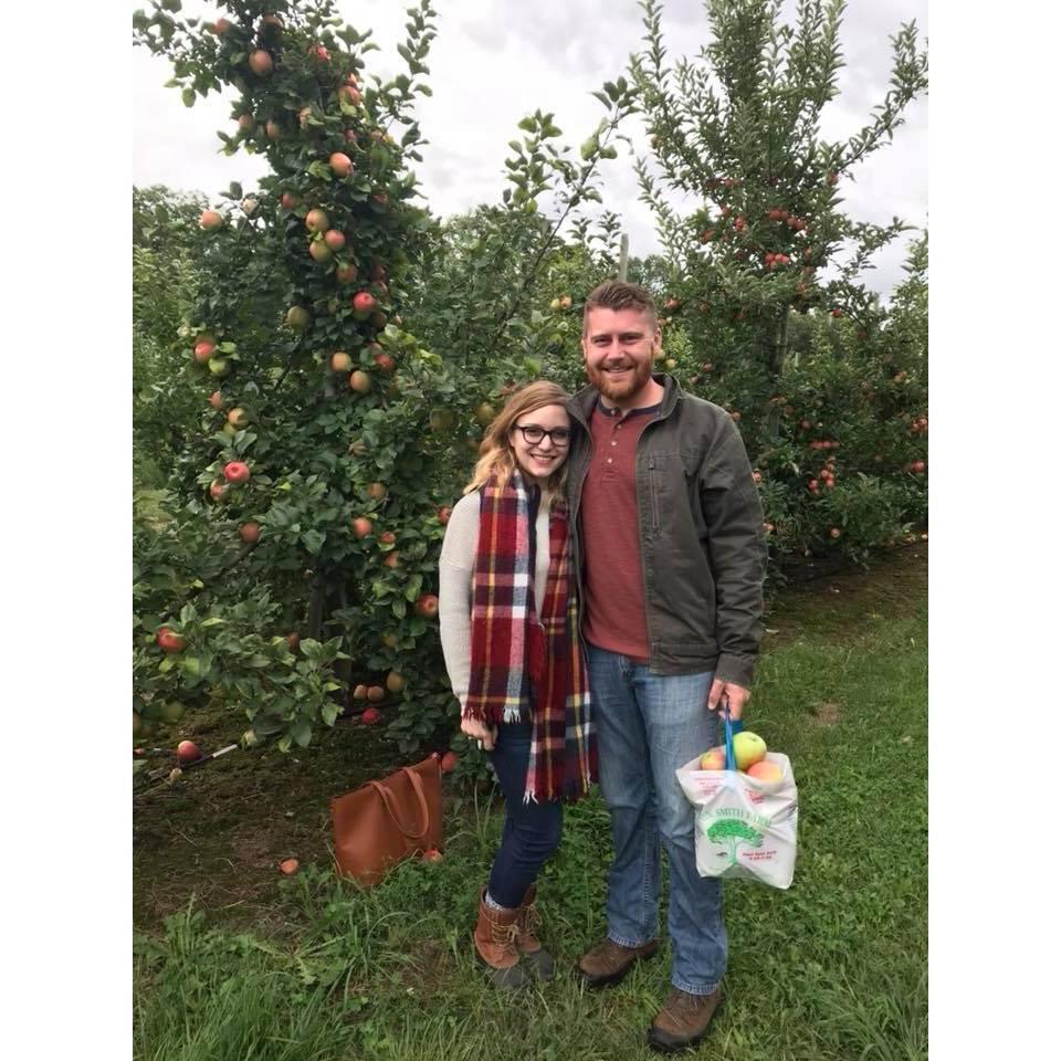 Samantha loves fall and Liam gladly indulges her with annual apple picking adventures (he's great at getting the apples high up). This is why they chose an orchard for their engagement pictures.