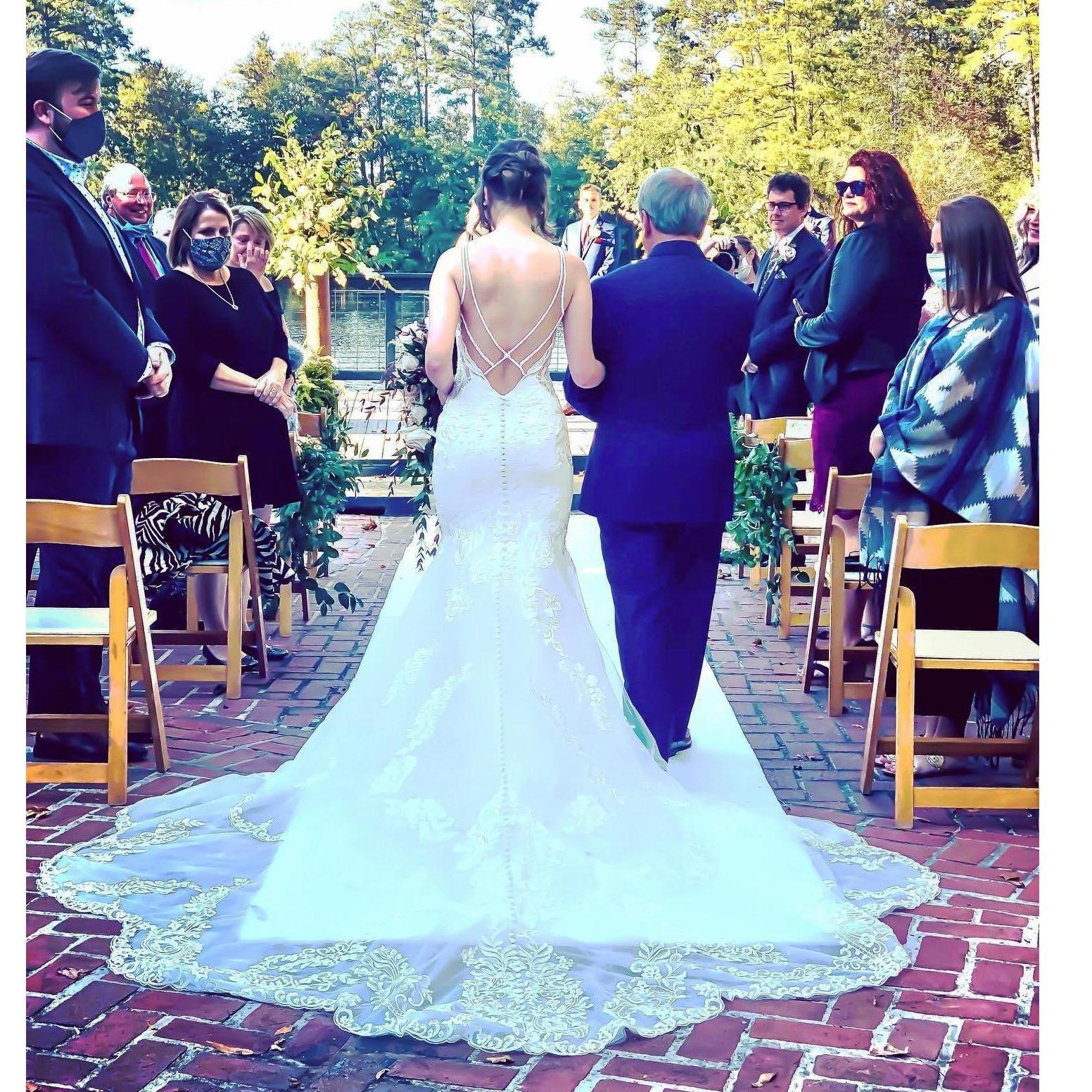 My father walks me down the aisle at Millstone at Adams Pond