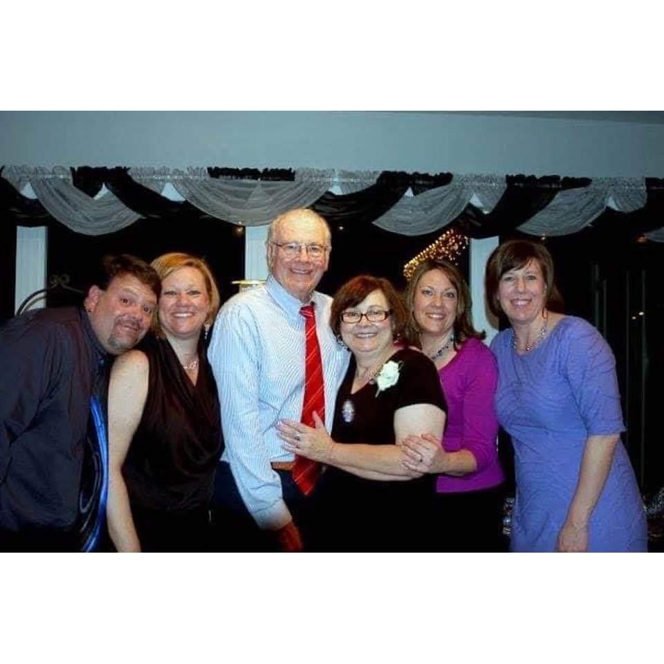 John with his parents and sisters several years ago