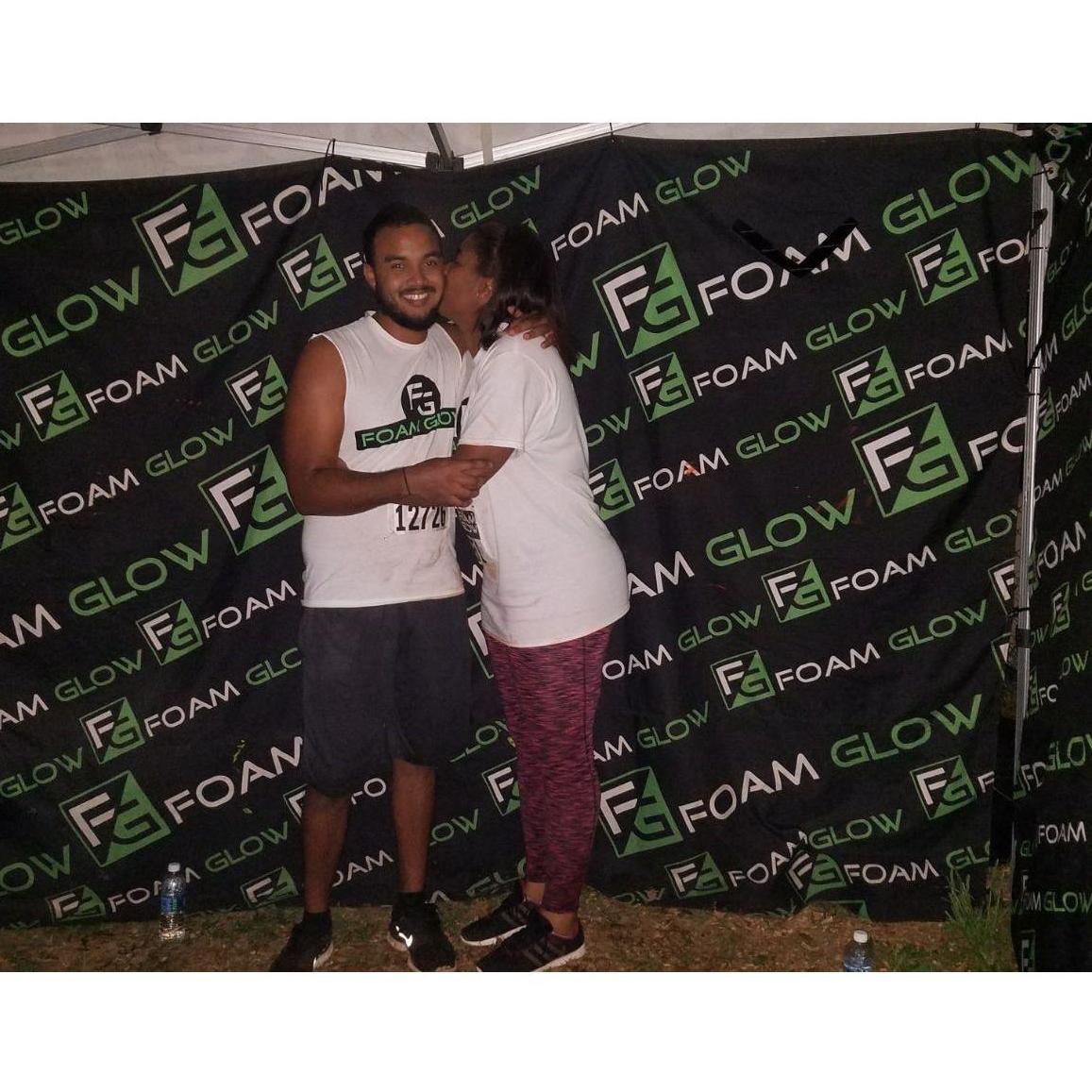 A quick celebratory kiss for finishing the Foam Glow 5k together.