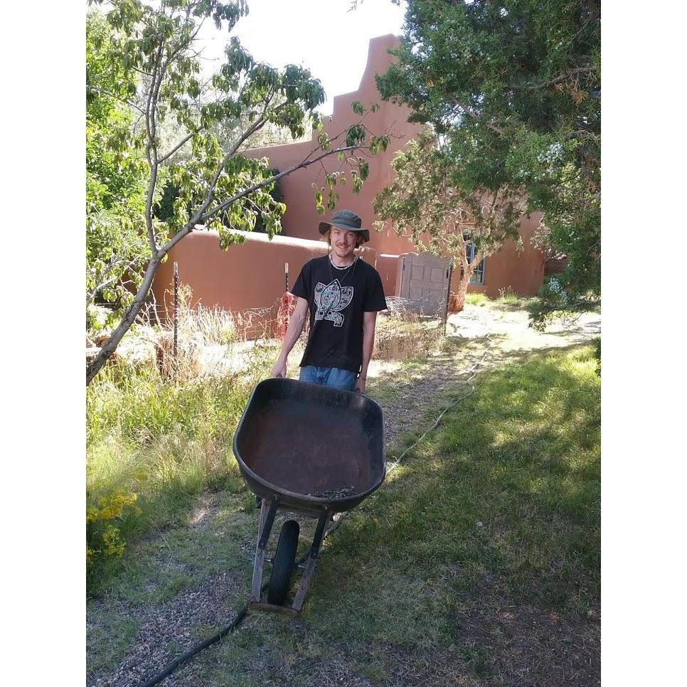 Ty working on the property of the geodesic dome greenhouse he manages.