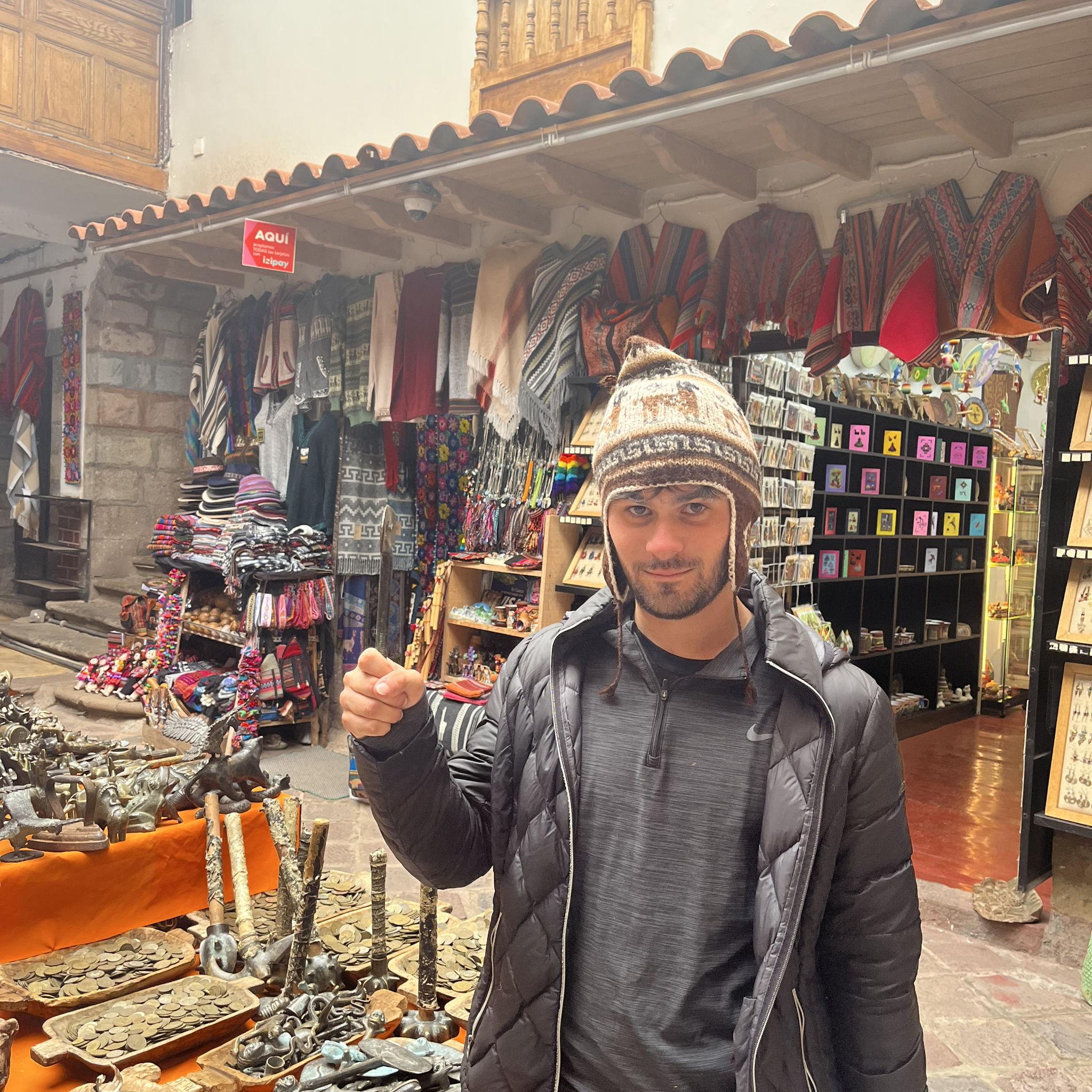 James holding a ceremonial axe menacingly at the local markets in Cusco, Peru