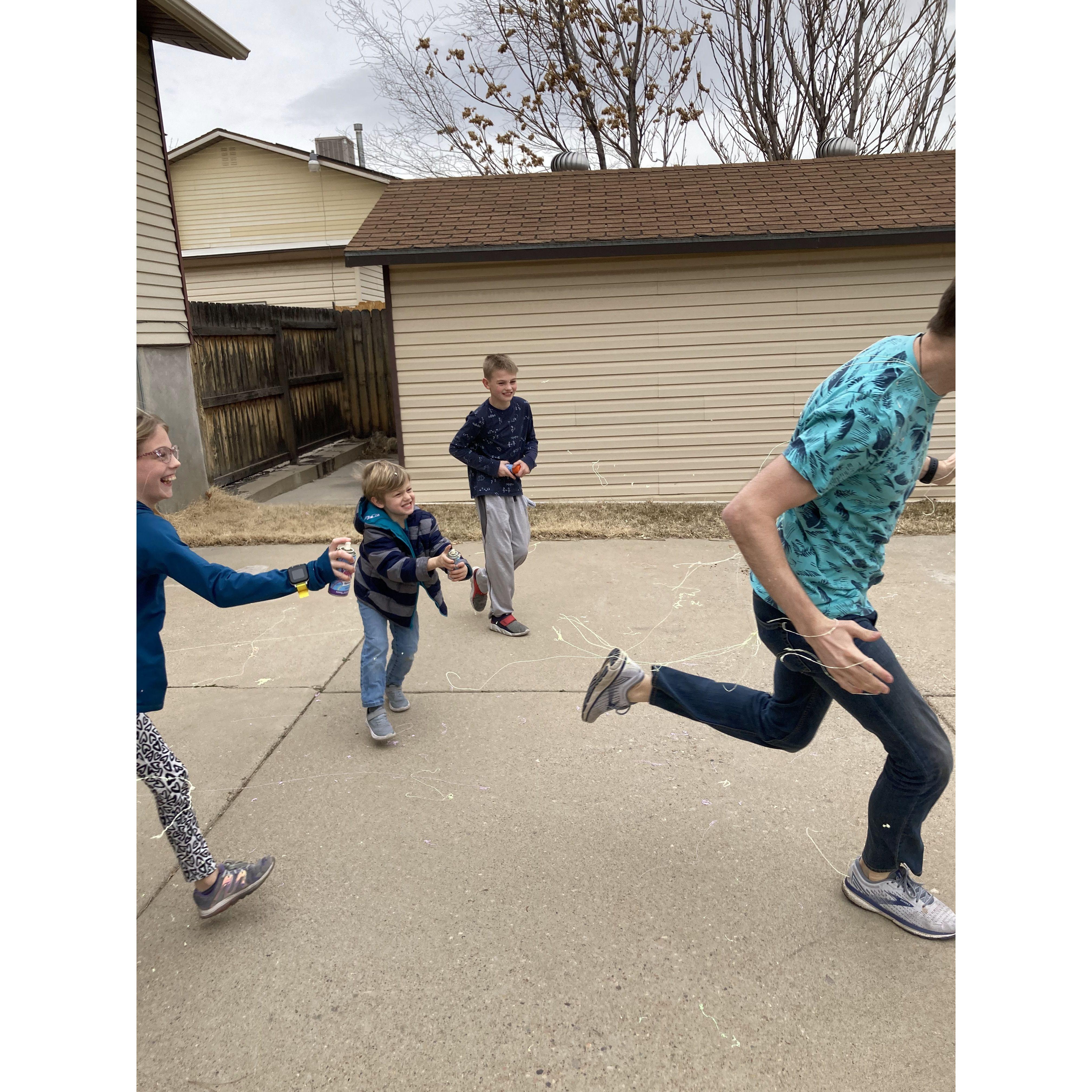 Jackie organized a silly string fight with the kids against Adam.
