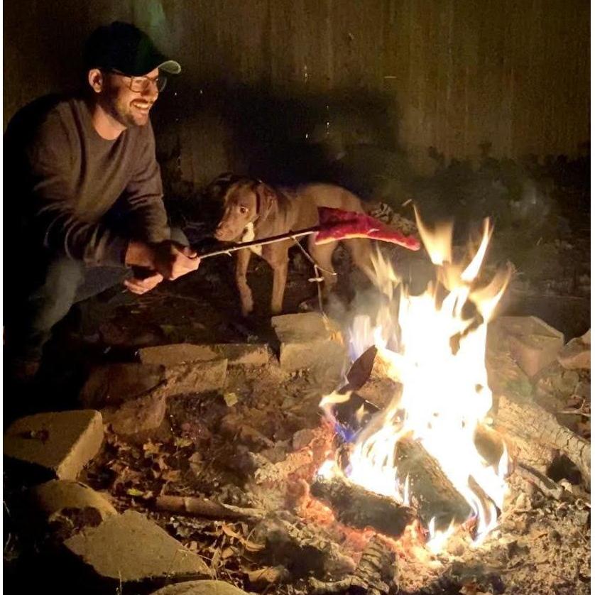 Elias in his element: attempting to heat pizza on a stick over the fire in our backyard.
Roxy in her element: waiting to swoop in when Elias inevitably drops said pizza.