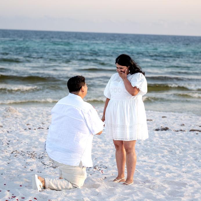 On their seventh year anniversary, Aldo got on one knee and proposed during an early summer sunset in front of Santa Rosa's emerald waters in Florida.