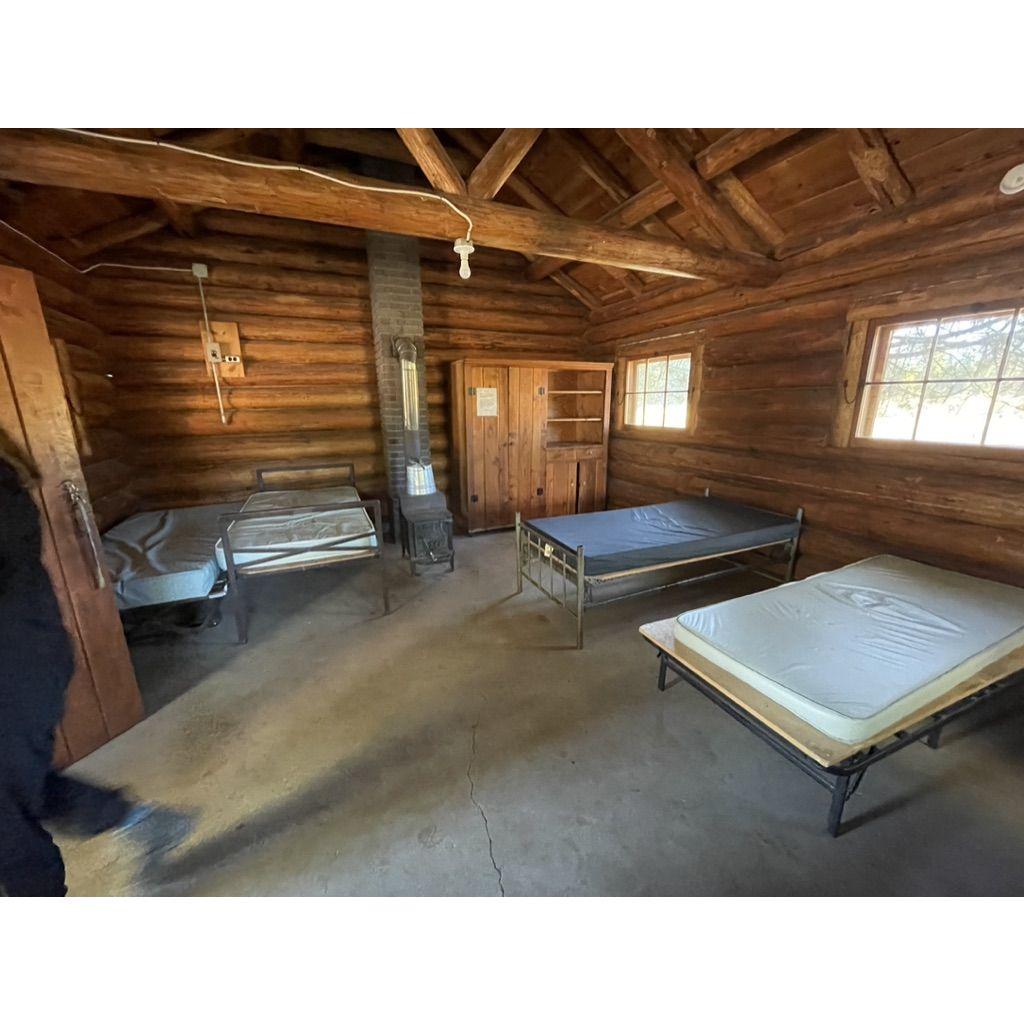 Camp Paxson cabin interior. Most have bunk beds, some have these frame beds & a wood stove. It's like camping but nicer.