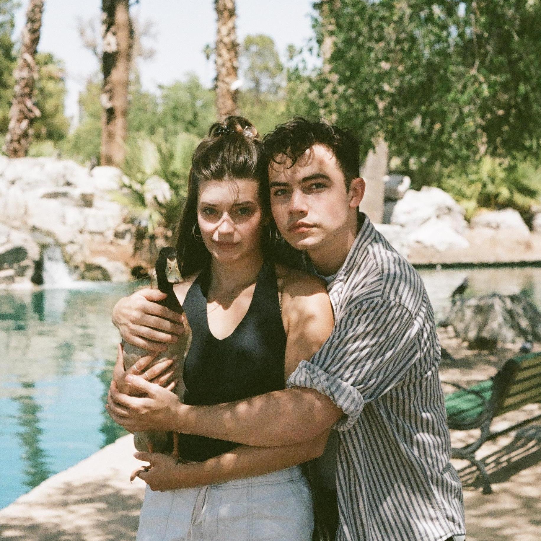 Madison and Isaac with a duck in a park in Phoenix