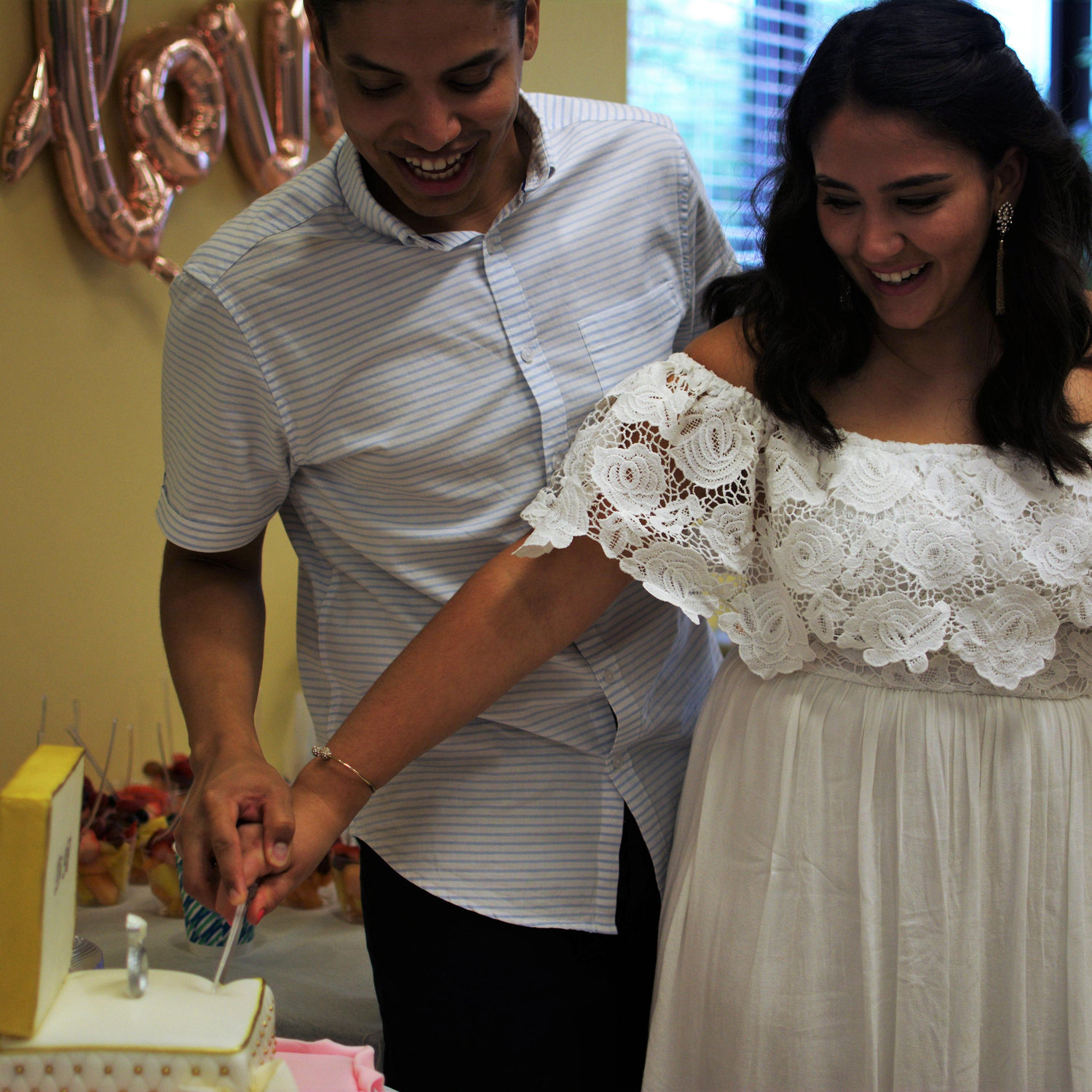 Cutting our first cake together at our engagement party!
