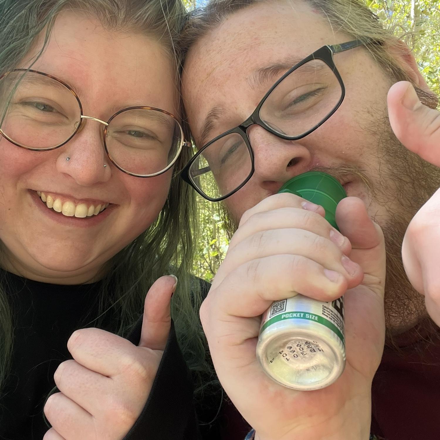 Trevor taking in some much needed canned oxygen on a hike in the mountains.