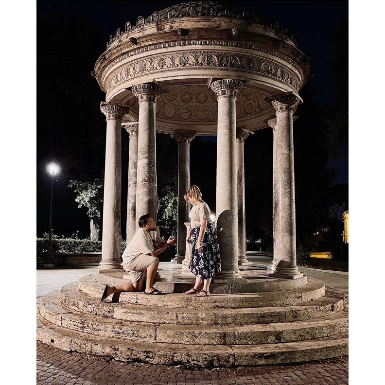 The 2nd night in Rome after dinner. The family said to go up to the statue to take a picture. She looked around & everyone had their phones out & there Justin is with the ring asking her to marry him.
