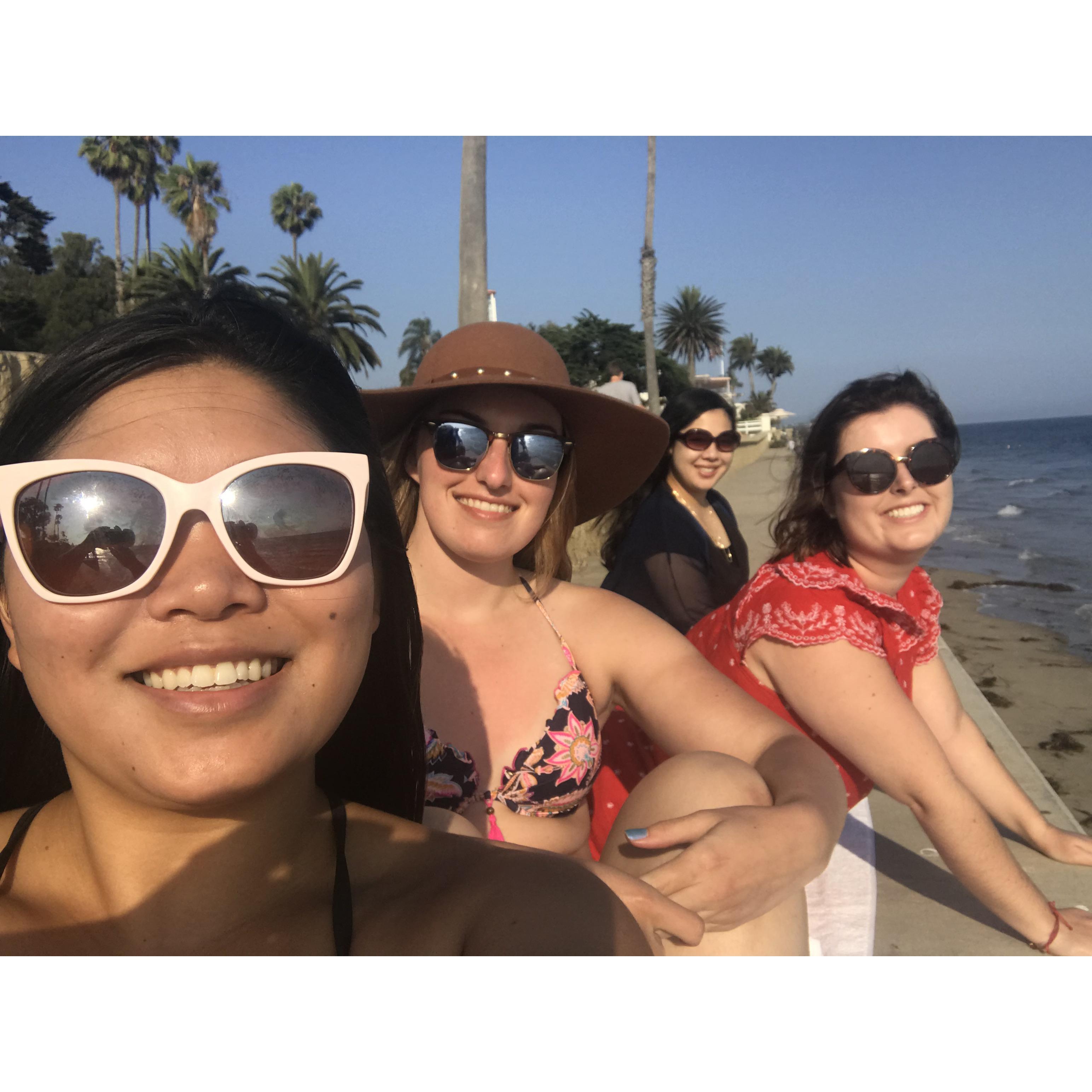 Kalia, Jessica, Katherine, and Nicole relaxing on a beach during Jessica's bachelorette weekend