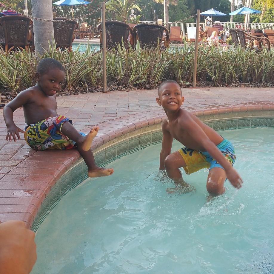 Mini Vacay: These are our boys, Dekilo and Bryce, hanging at the pool on one of our many trips to Orlando. Bryce was afraid to get in, so big brother had to show him how to have some fun!