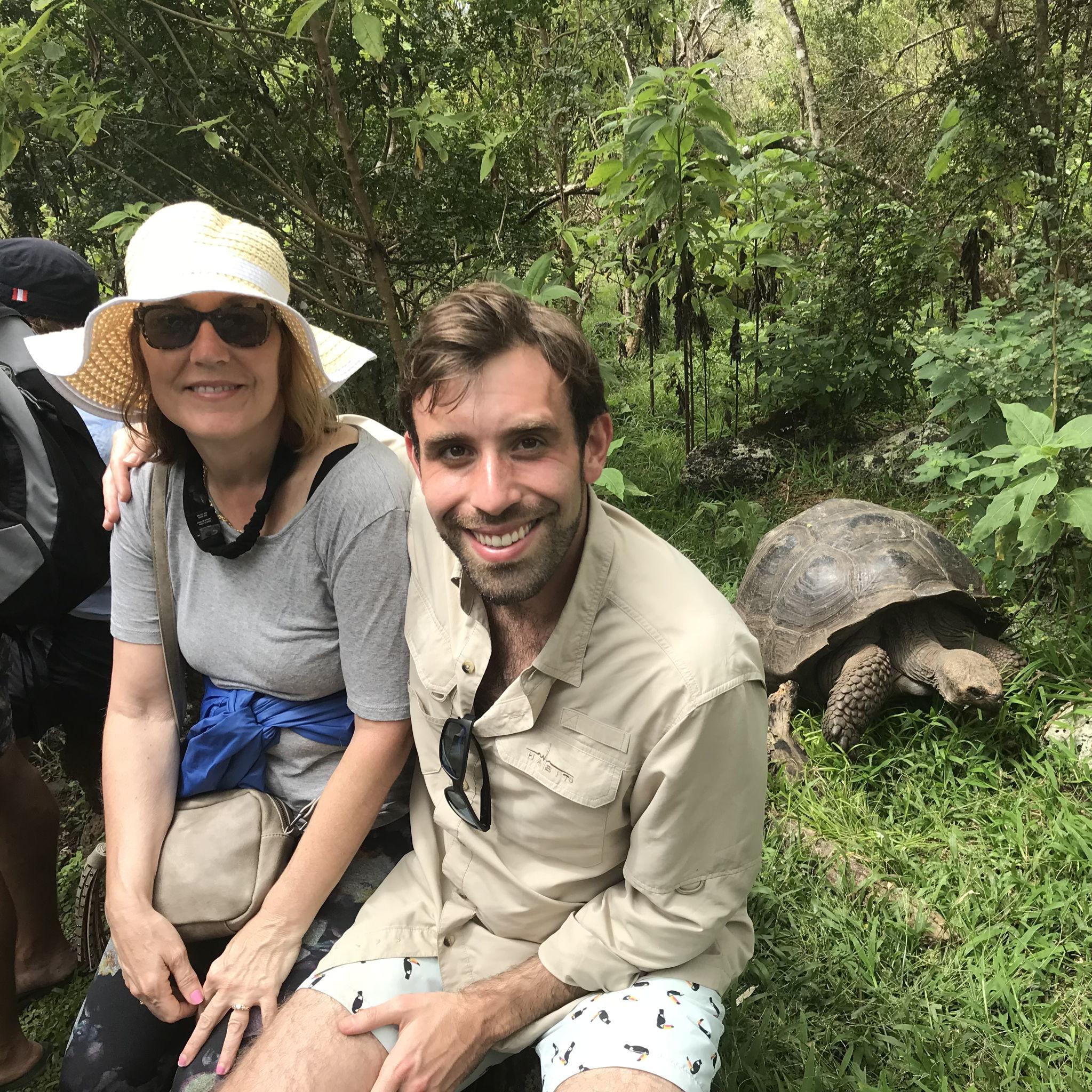 Galapagos - Michael and Denise by a giant Galápagos turtle—did you know these gentle giants can live 100 years or more?
