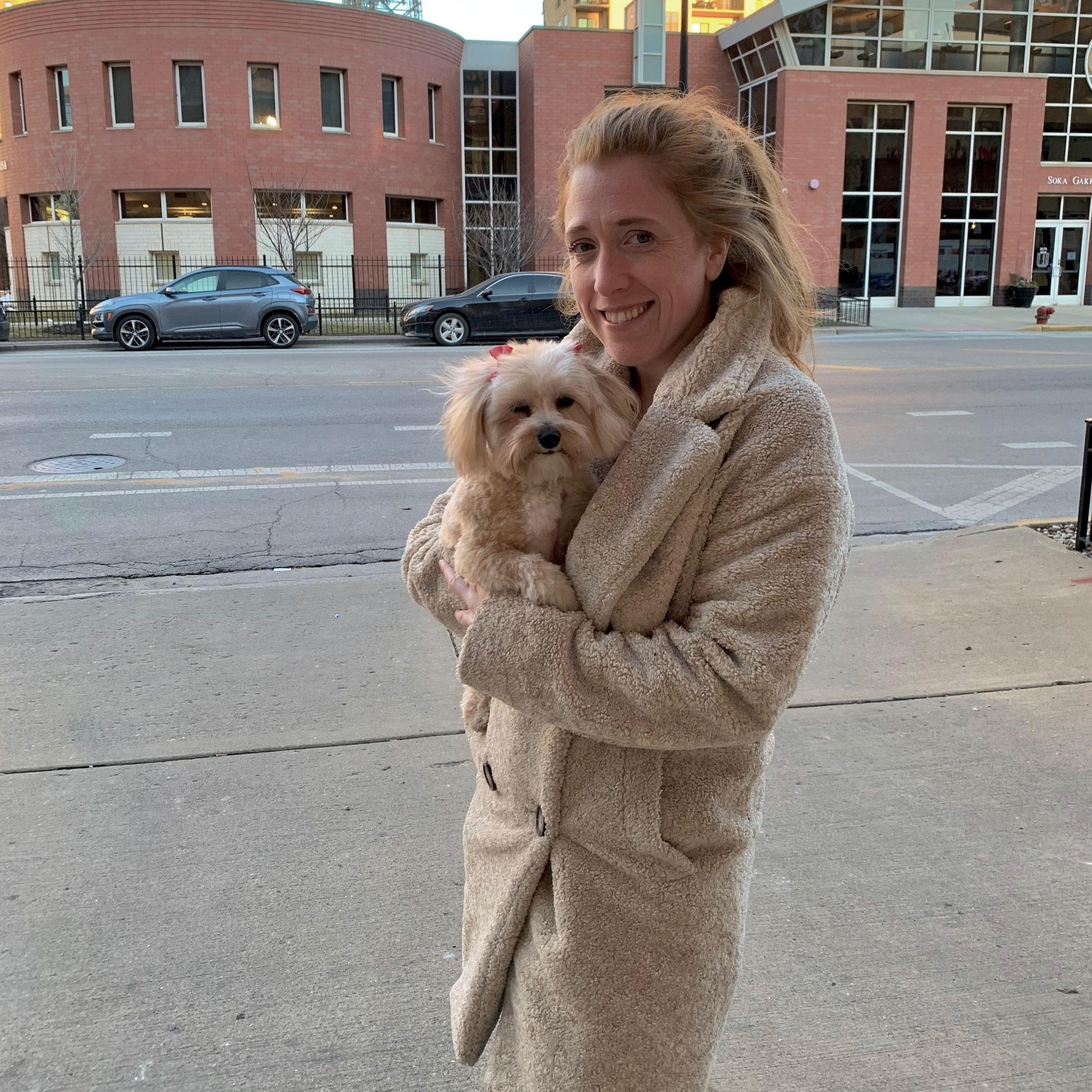 Andrea's love of her dogs is undeniable. Here she is trying to match outfits with Pebbles