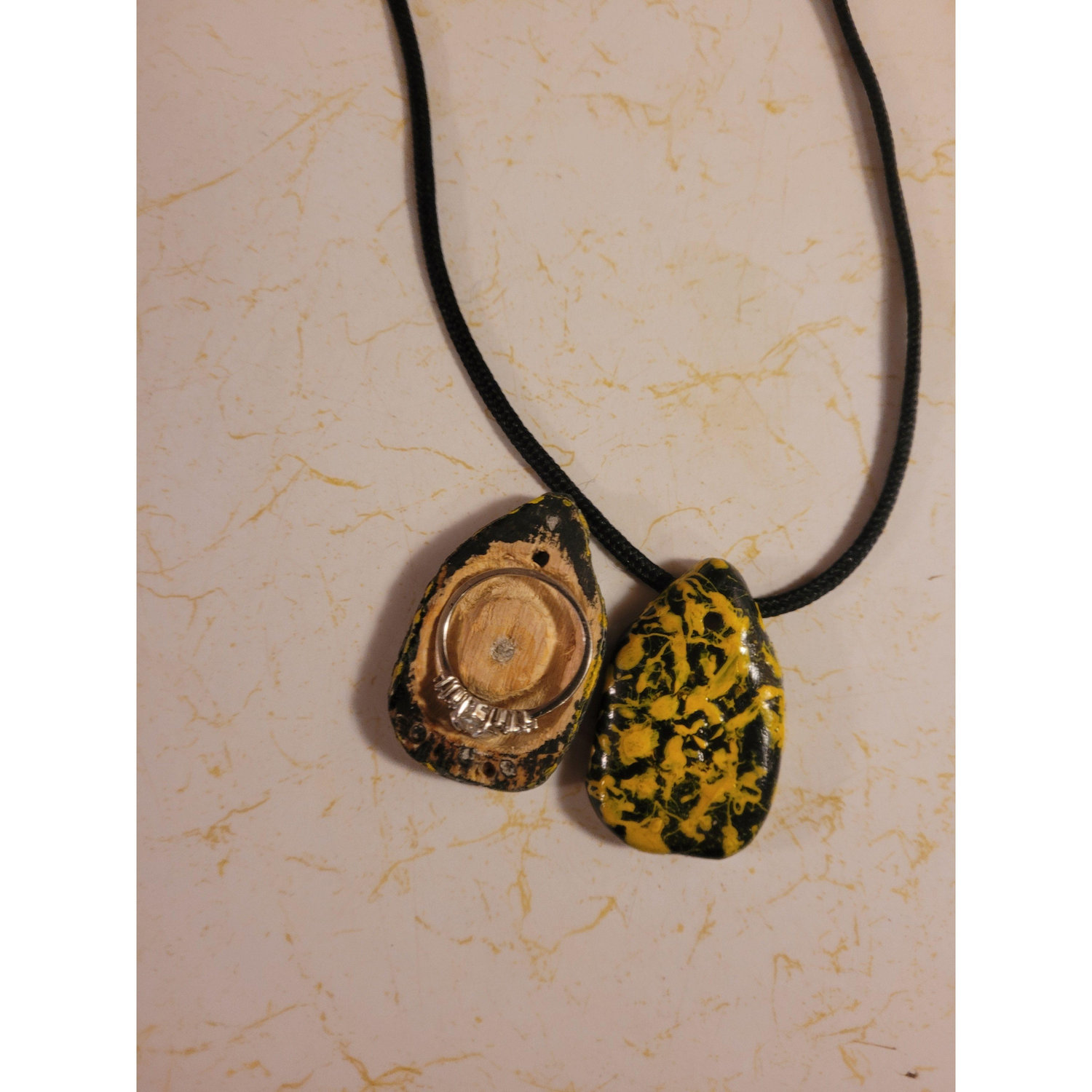 The necklace he hid my ring in before proposing. I put the ring back for this photo to show what a perfect fit he made.