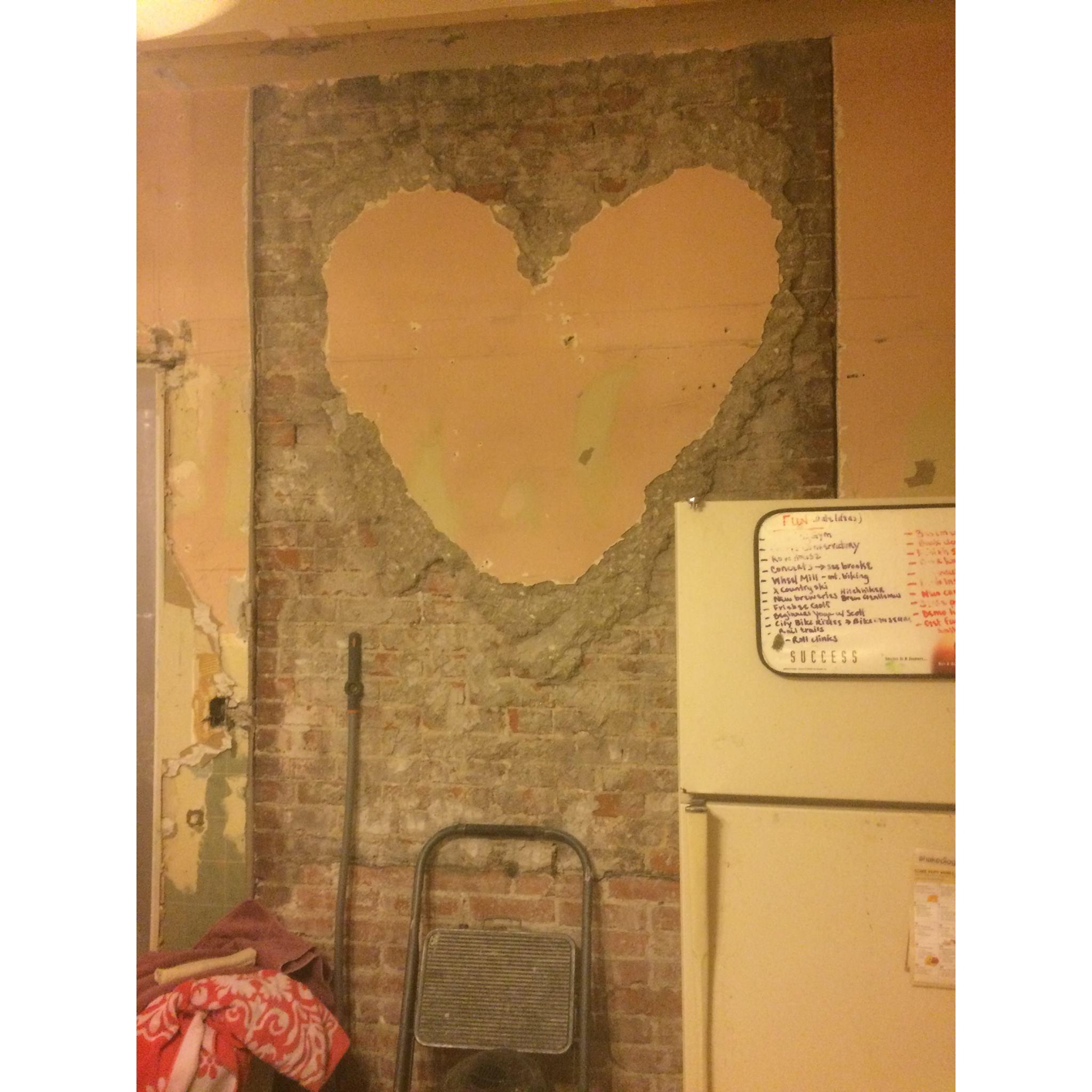 Scott is a true romantic! I came home to find this heart he left in the plaster as he was working on remodeling the kitchen and exposing the brick fireplace.