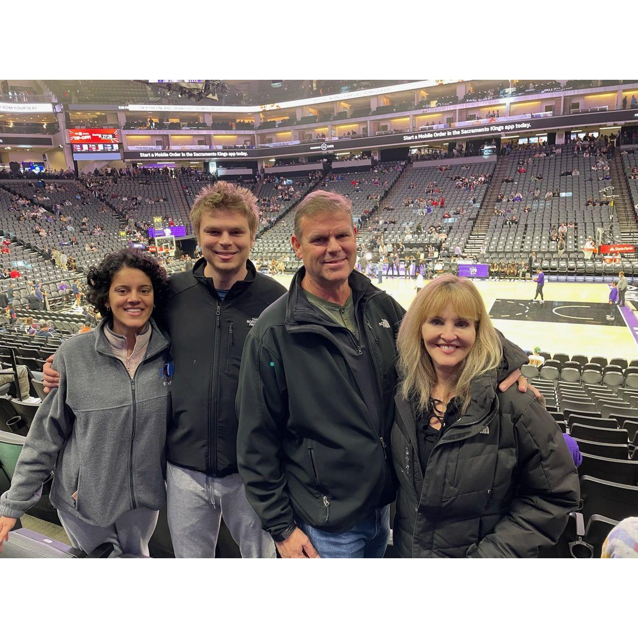 At a basketball game with Chris's father Ross and his wife Rebecca.