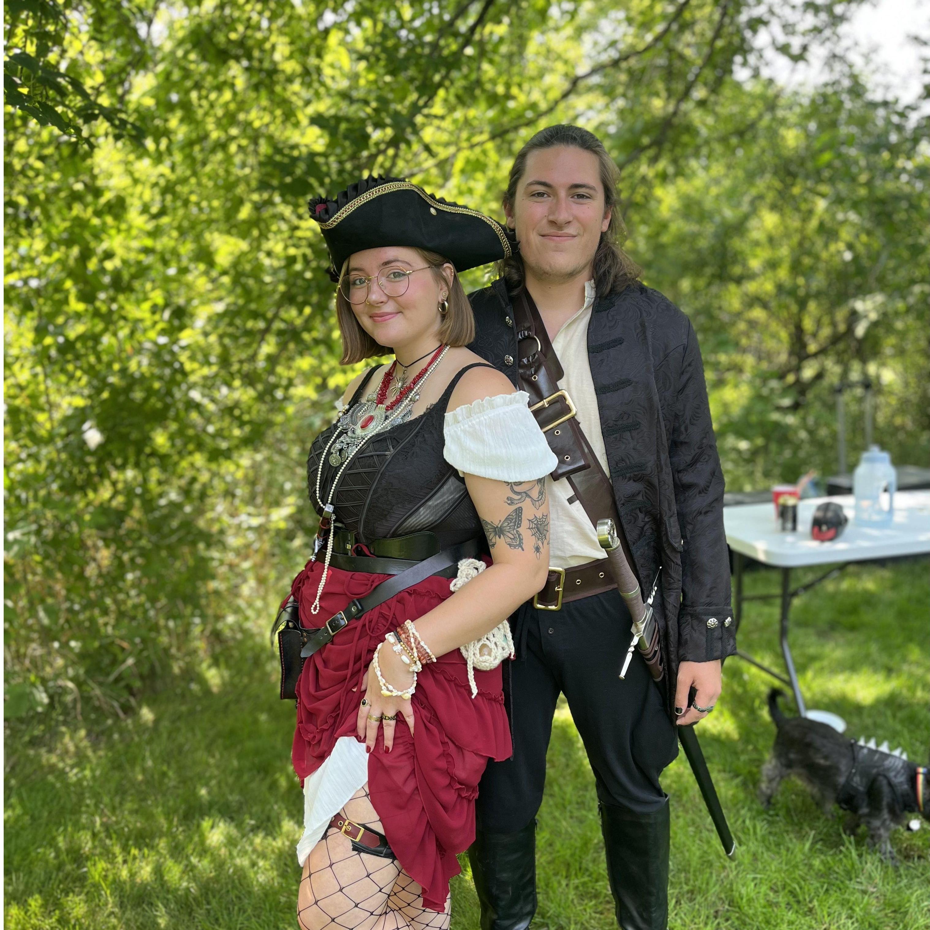 Renaissance festival 2024 - Alex and Caitlyn dressed as pirates! Do not wear a costume such as that seen here, but please do add medieval jewelry, a corset, leather belts, or even fishnet tights.