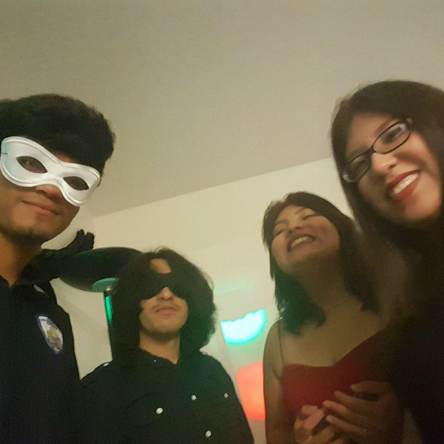 A group photo from a Masquarade Party. (Kenny on the far left and Mary on the far right). May 2017.