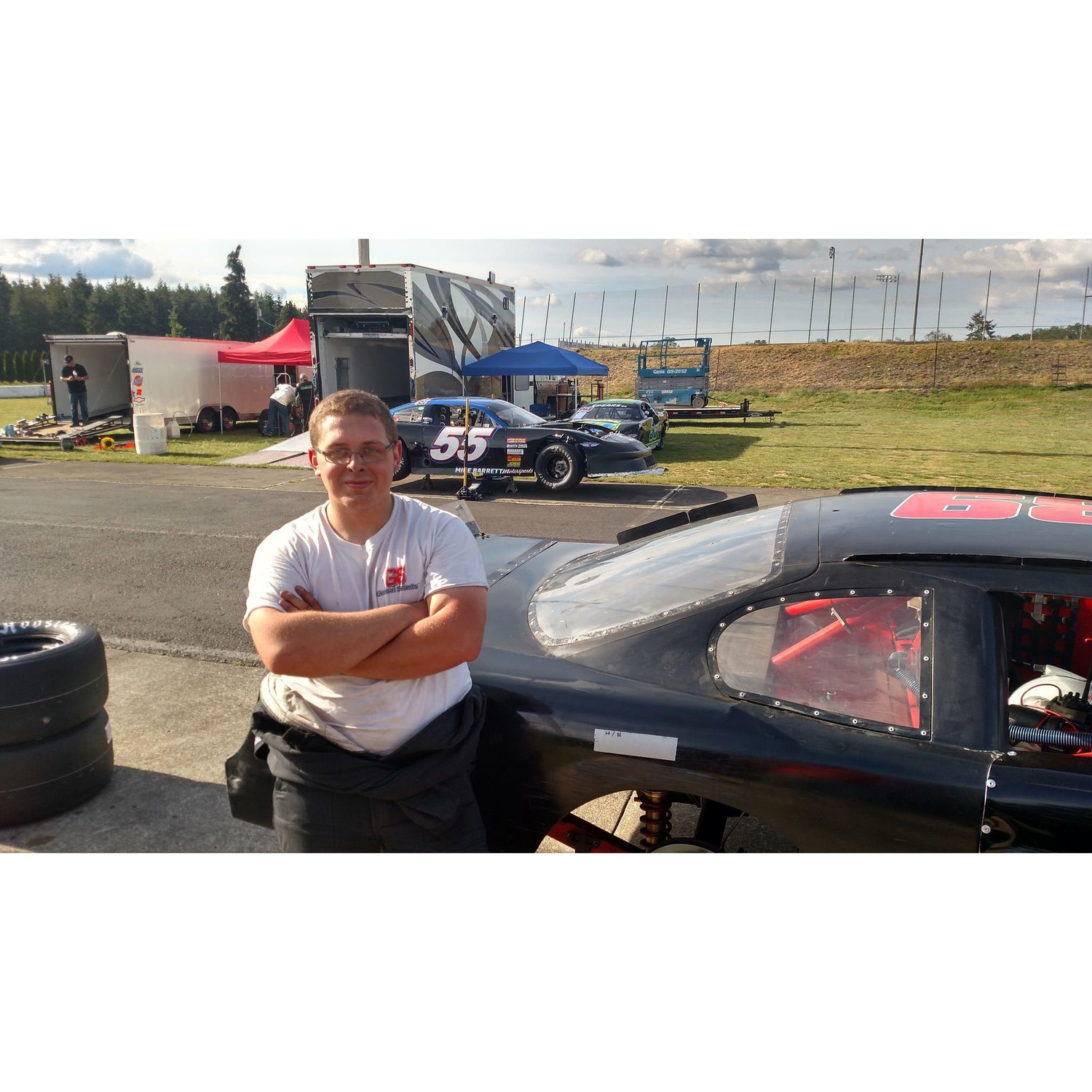 Groomsman Patrick resting on his super late model asphalt circle track car