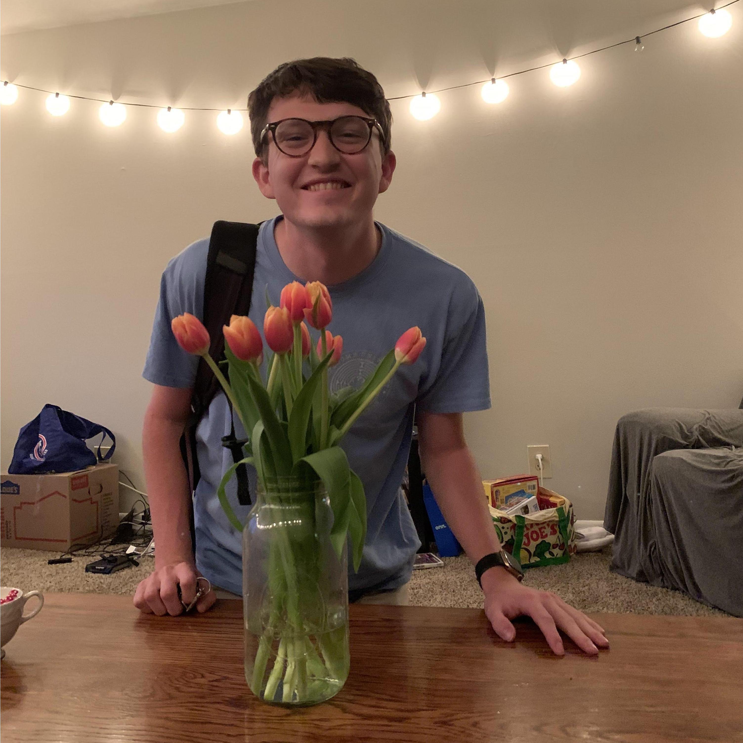Caleb posing with one of his Trader Joe flower choices!