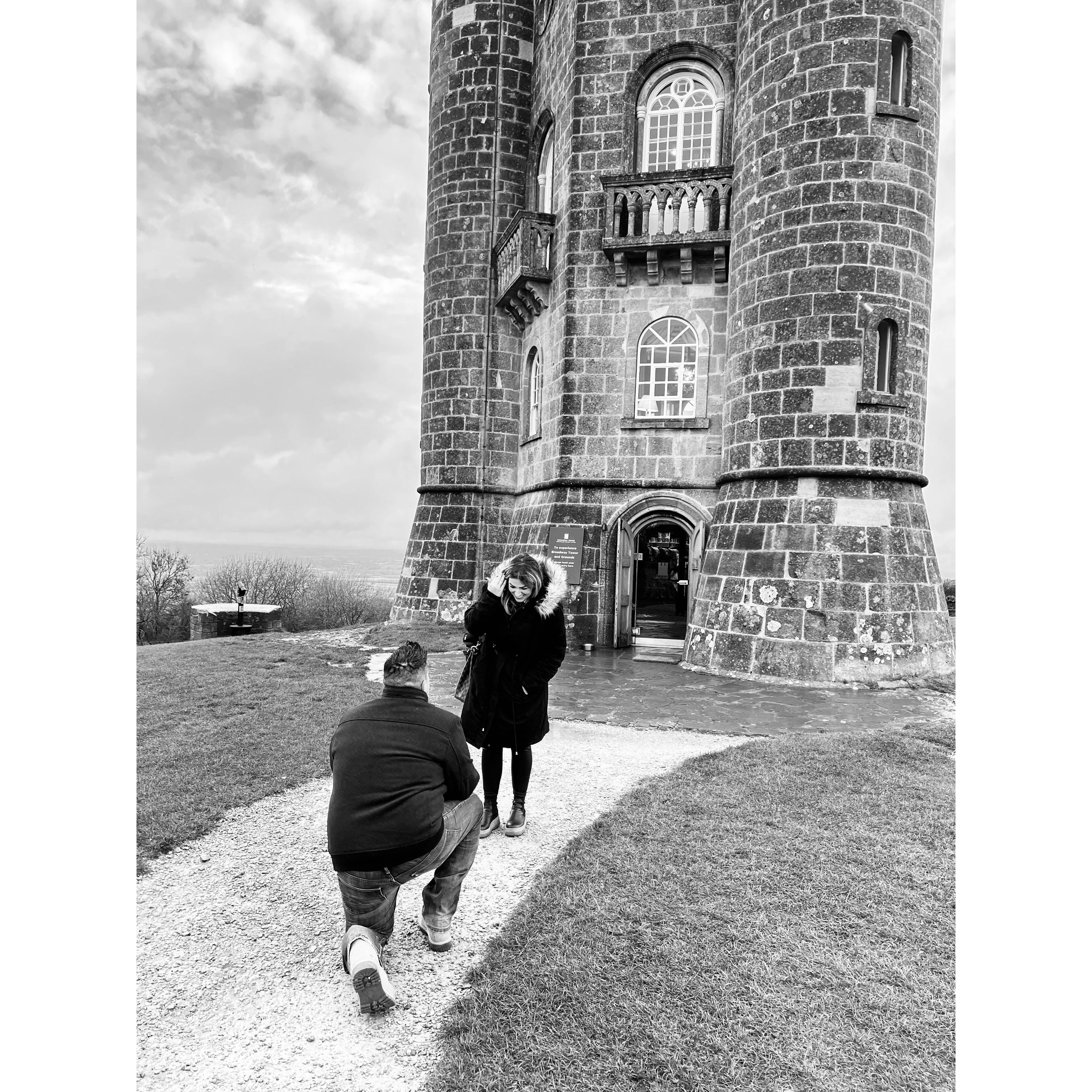 The moment he asked me to be his wife... followed by the easiest "yes" of my life. (Broadway Tower in Cotswolds, Engand)