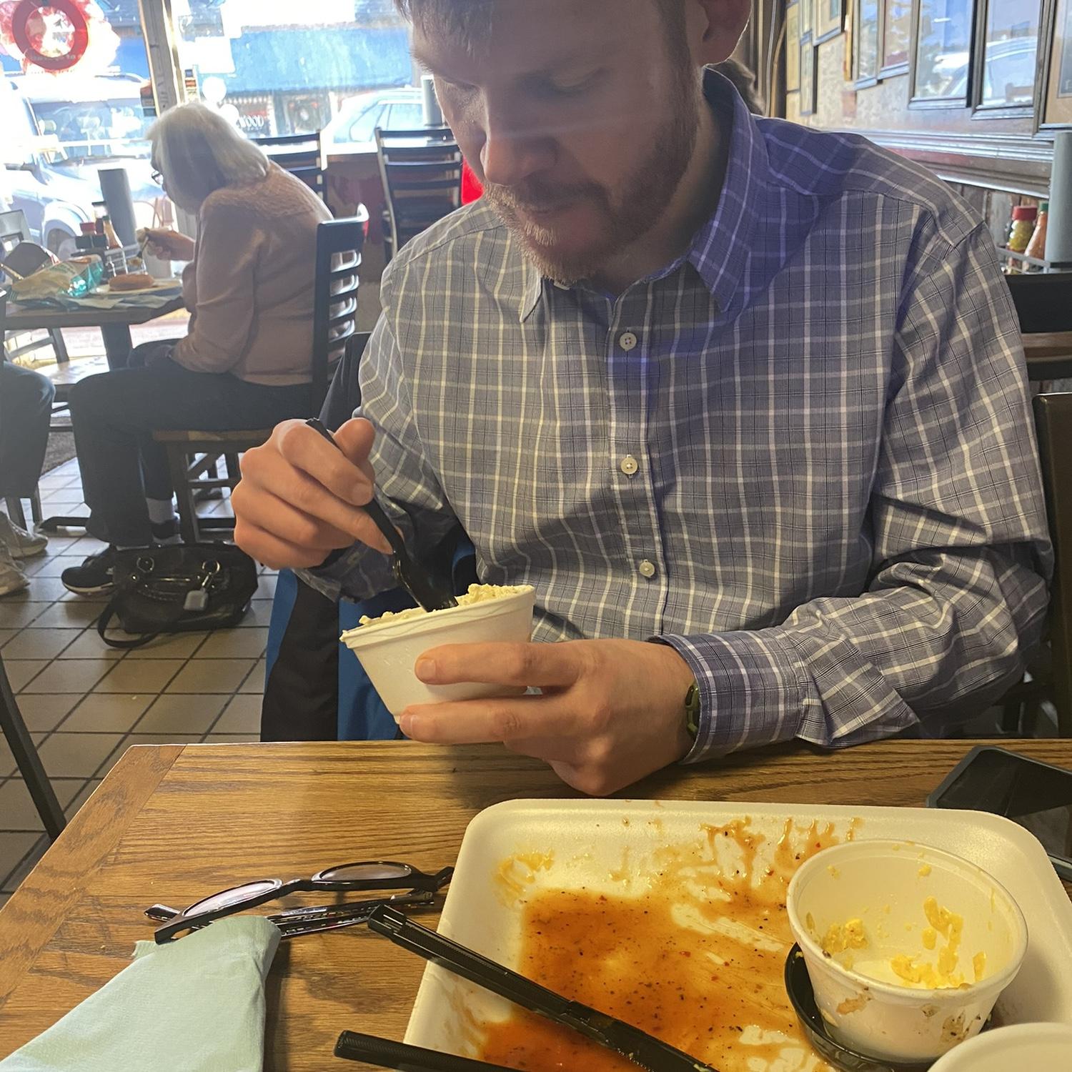 Gibbs’s first time trying BBQ in Birmingham! Notice the clean plate and glasses on the table.
