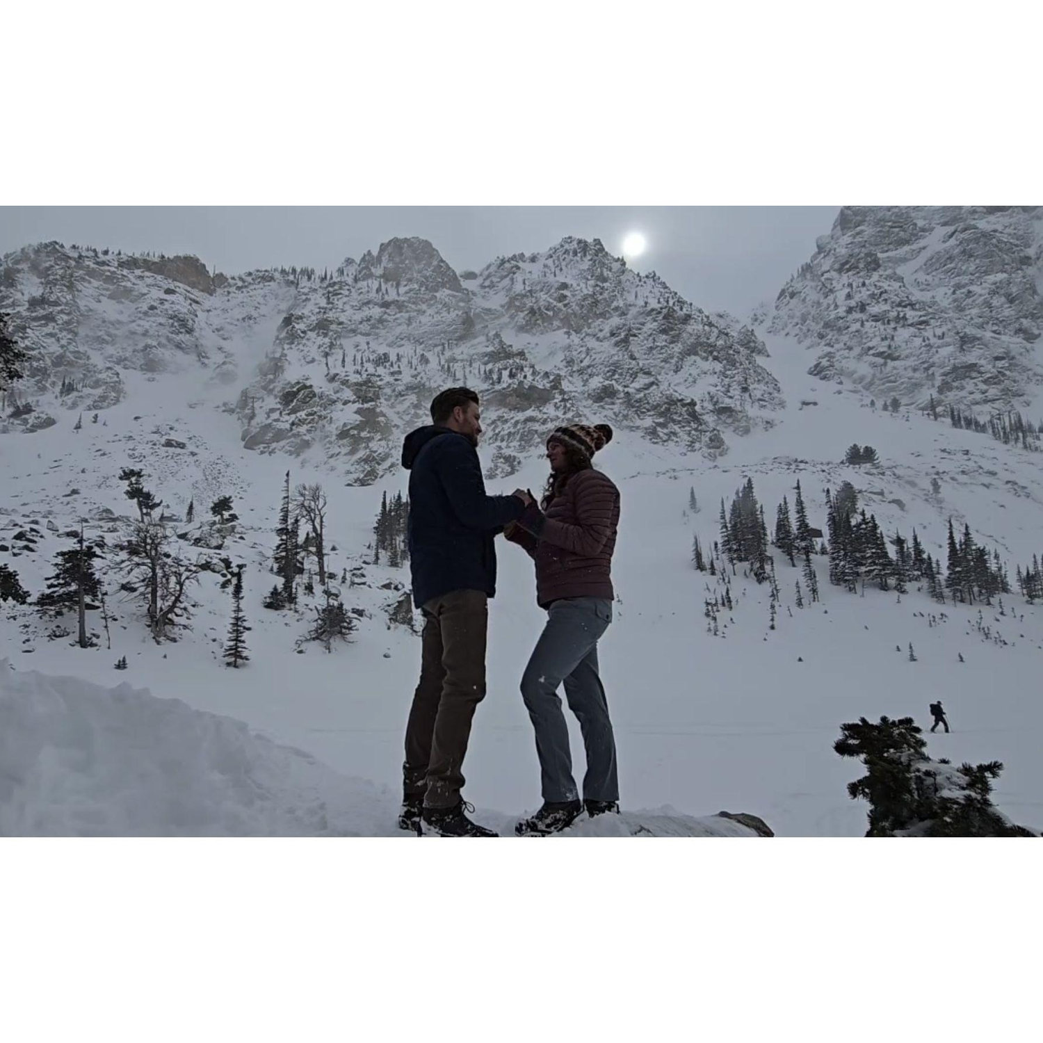 Todd proposing to Cassie in Rocky Mountain National Park. Don't let the look of the weather in this picture fool you; it was a magical winter day