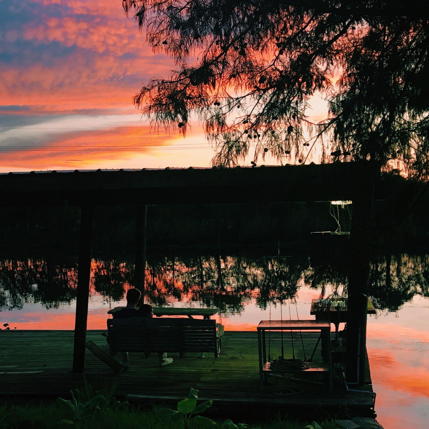 Enjoying a dramatic sunset on the dock along Bayou Terrebonne. The shrimp boots are a paid actor.