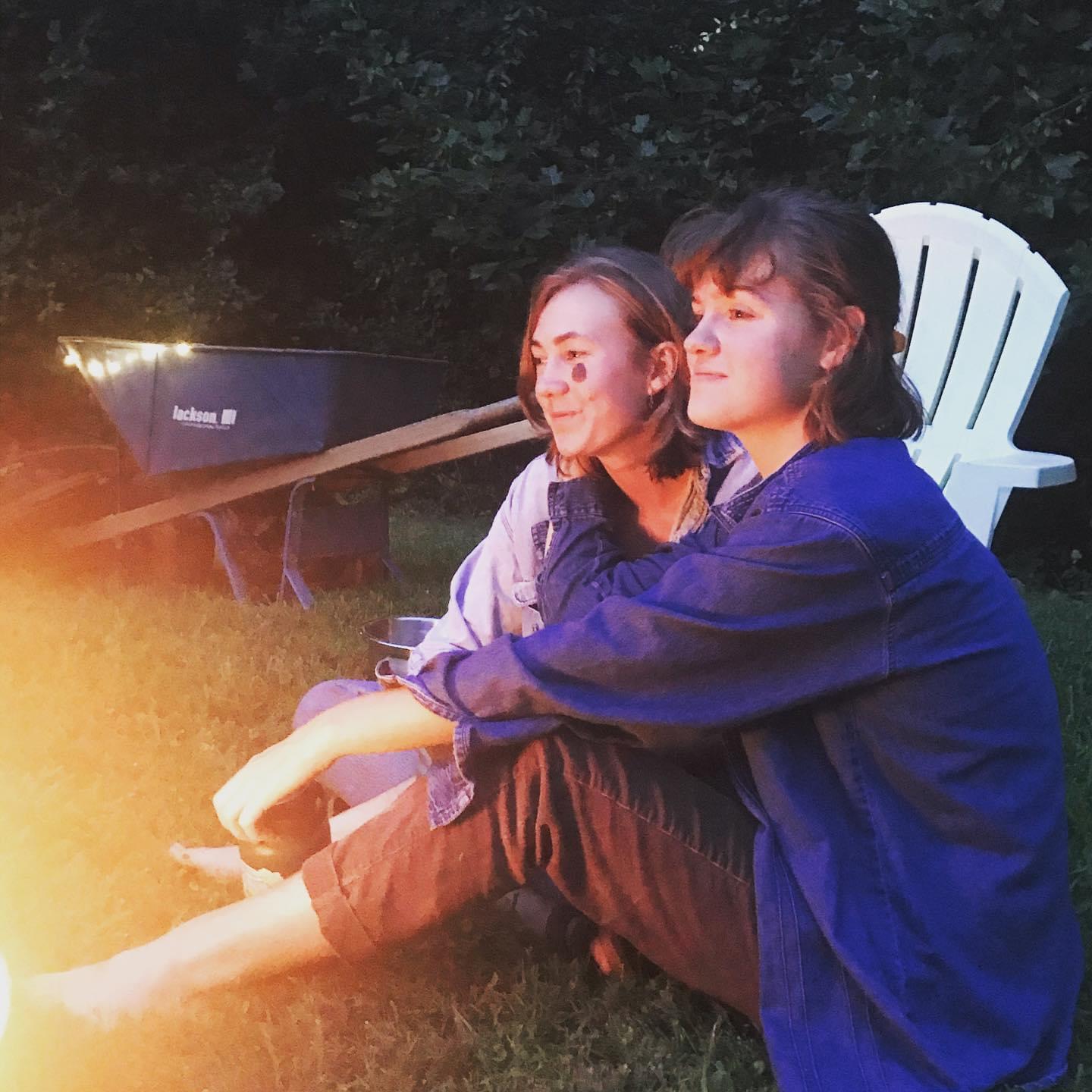 Snuggles near the fire on a summer night.