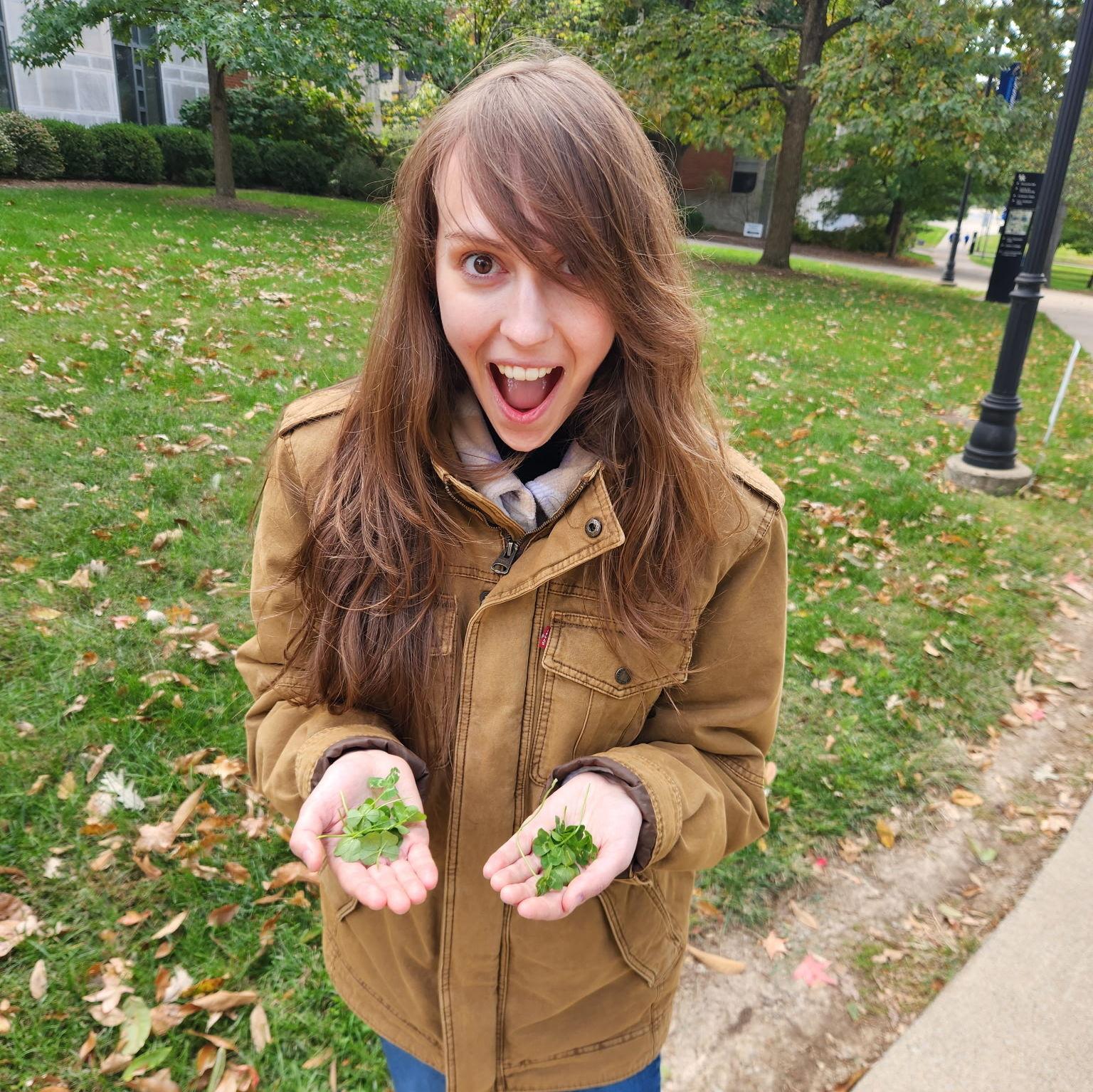 Holding 16 four-leaf clovers that we found together on UK's campus