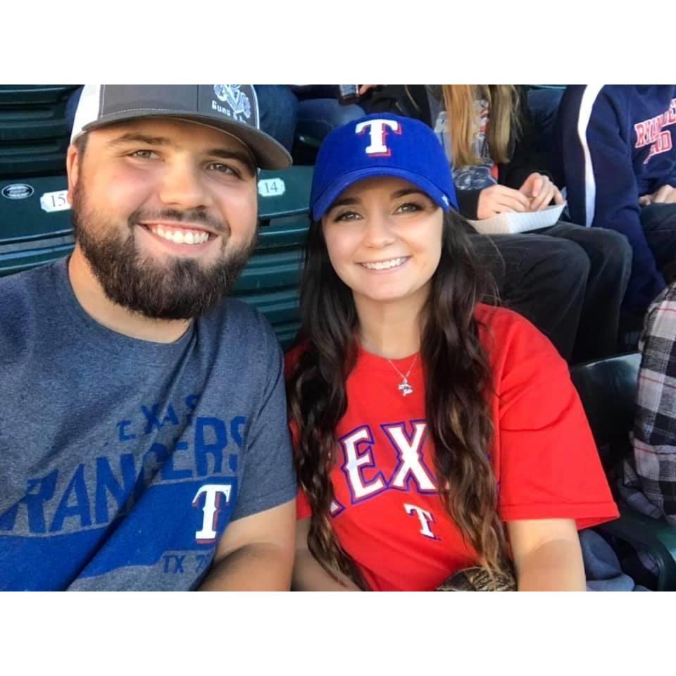 OUR FIRST TEXAS RANGERS BASEBALL GAME TOGETHER!
 HE'S A CARDINAL'S FAN SO I HAD TO FORCE HIM TO WEAR A RANGERS SHIRT.