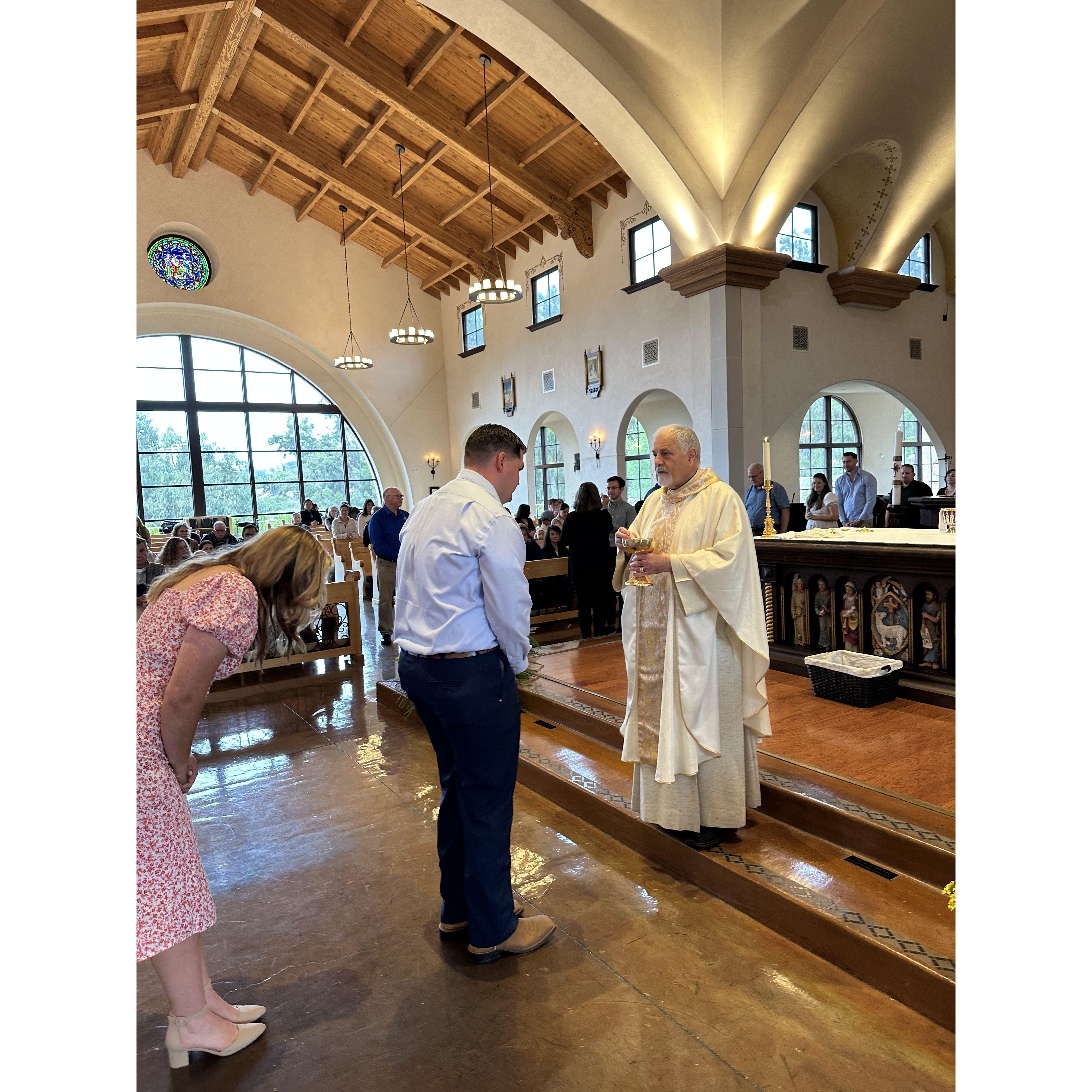 Isaiah receiving his first communion