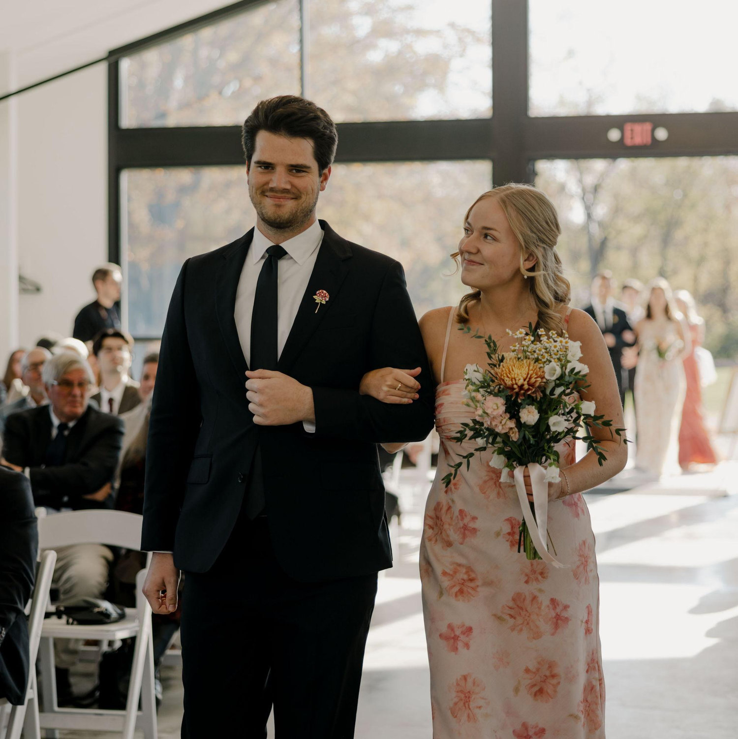 We walked down the aisle together at our friend's wedding who also met on the tennis team!