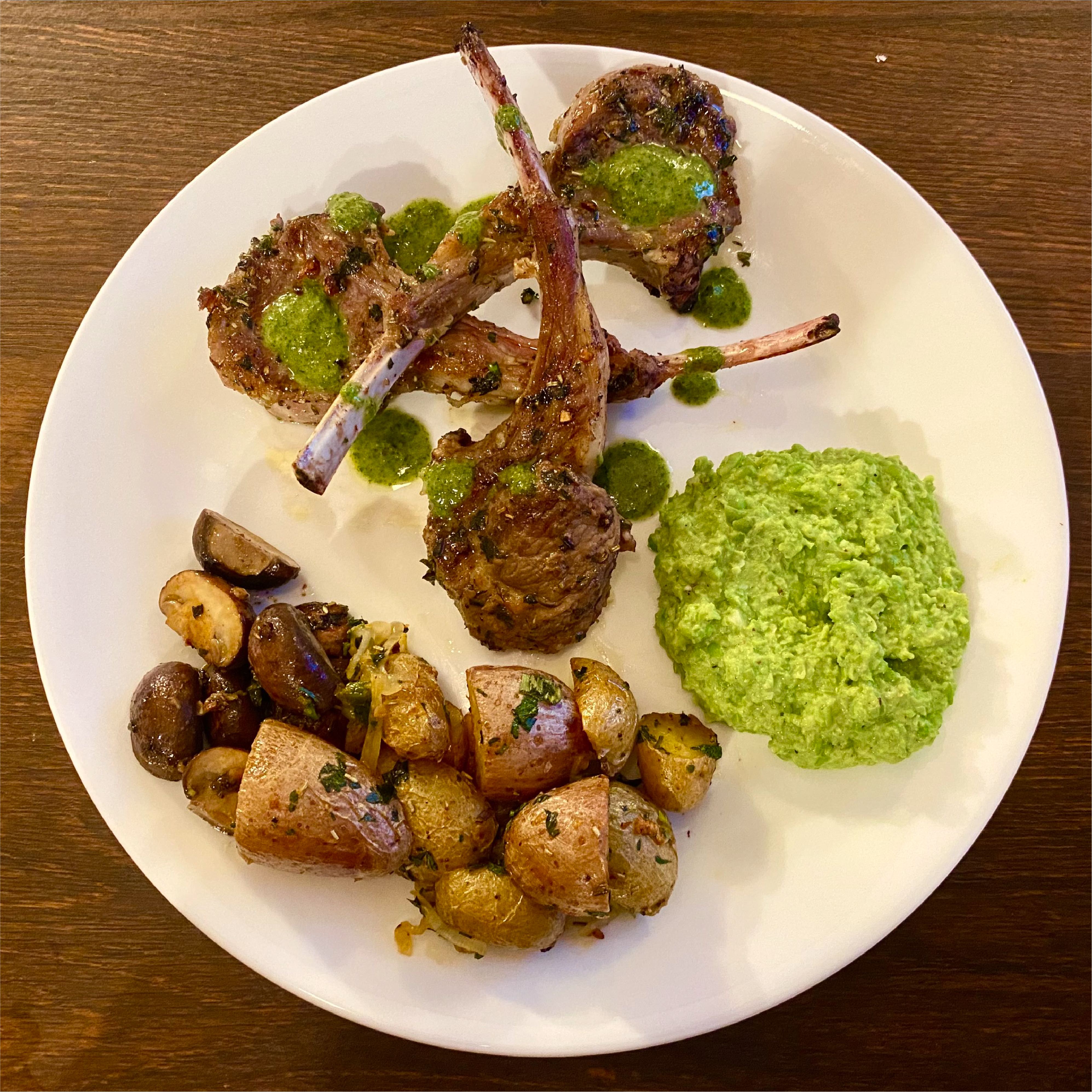 Arvin's herb-crusted rack of lamb with chimichurri sauce, smashed peas, and roasted potatoes.