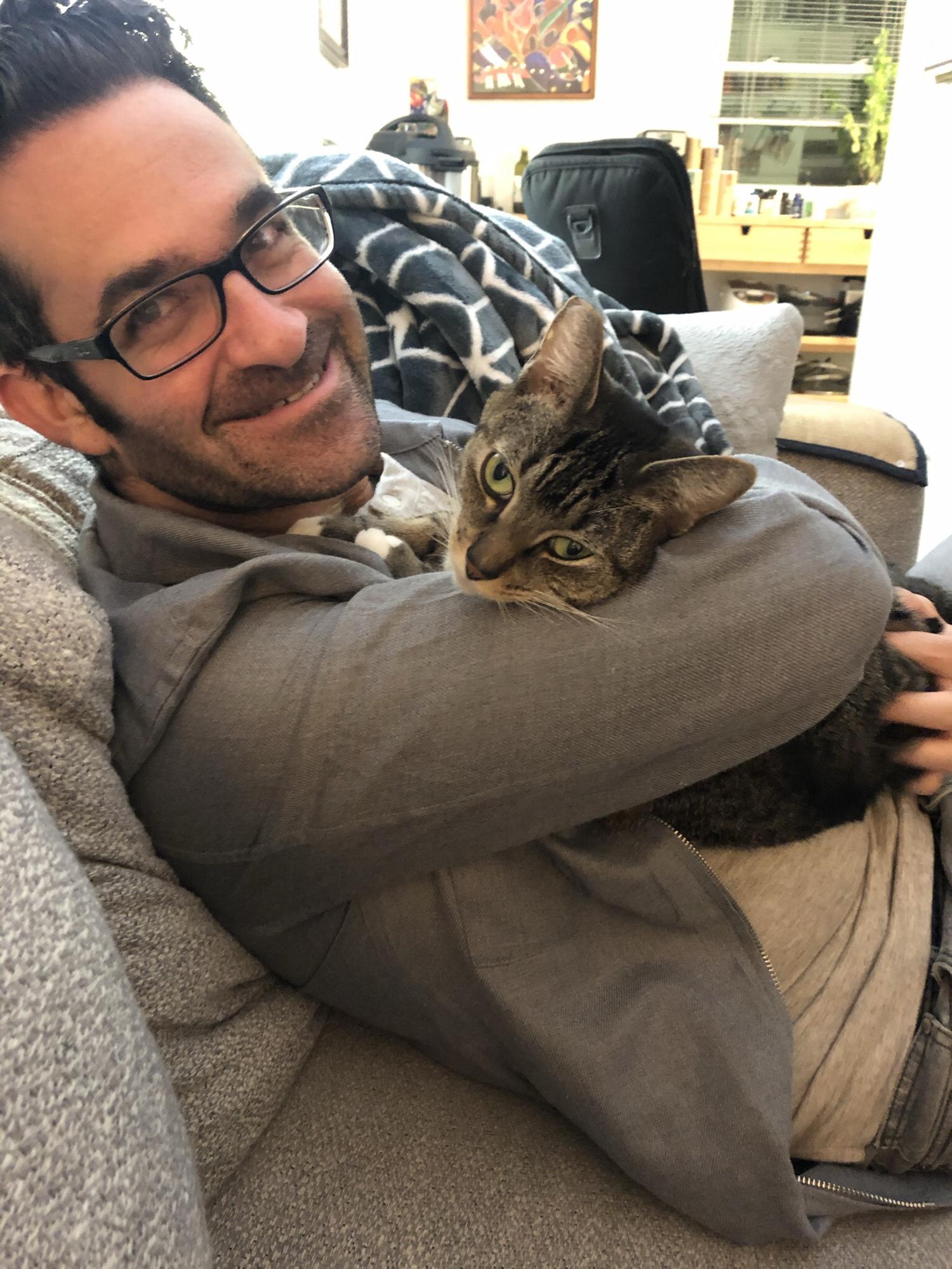 Love this pic of Michael with our feisty feline Mika