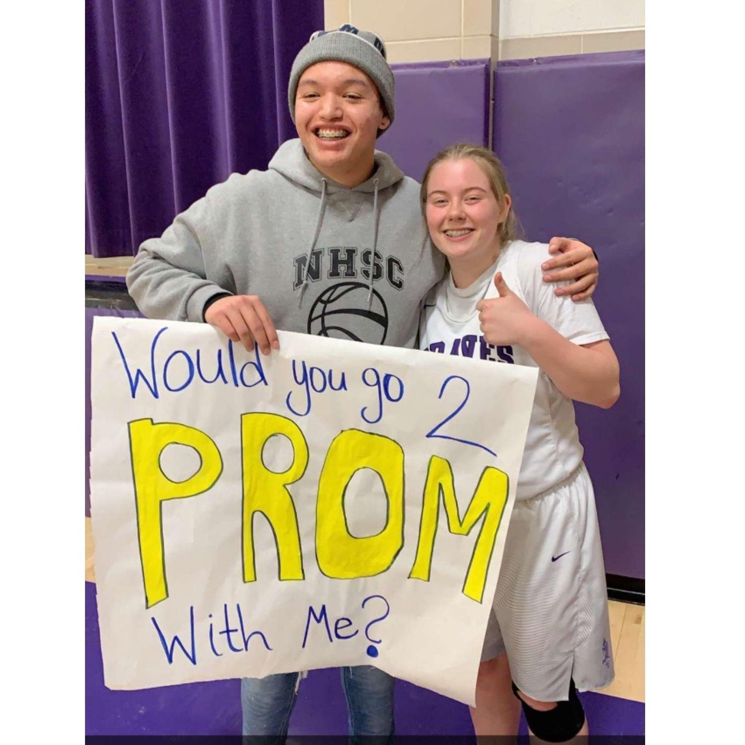 Wyatt promposing to Lexi after a basetball game