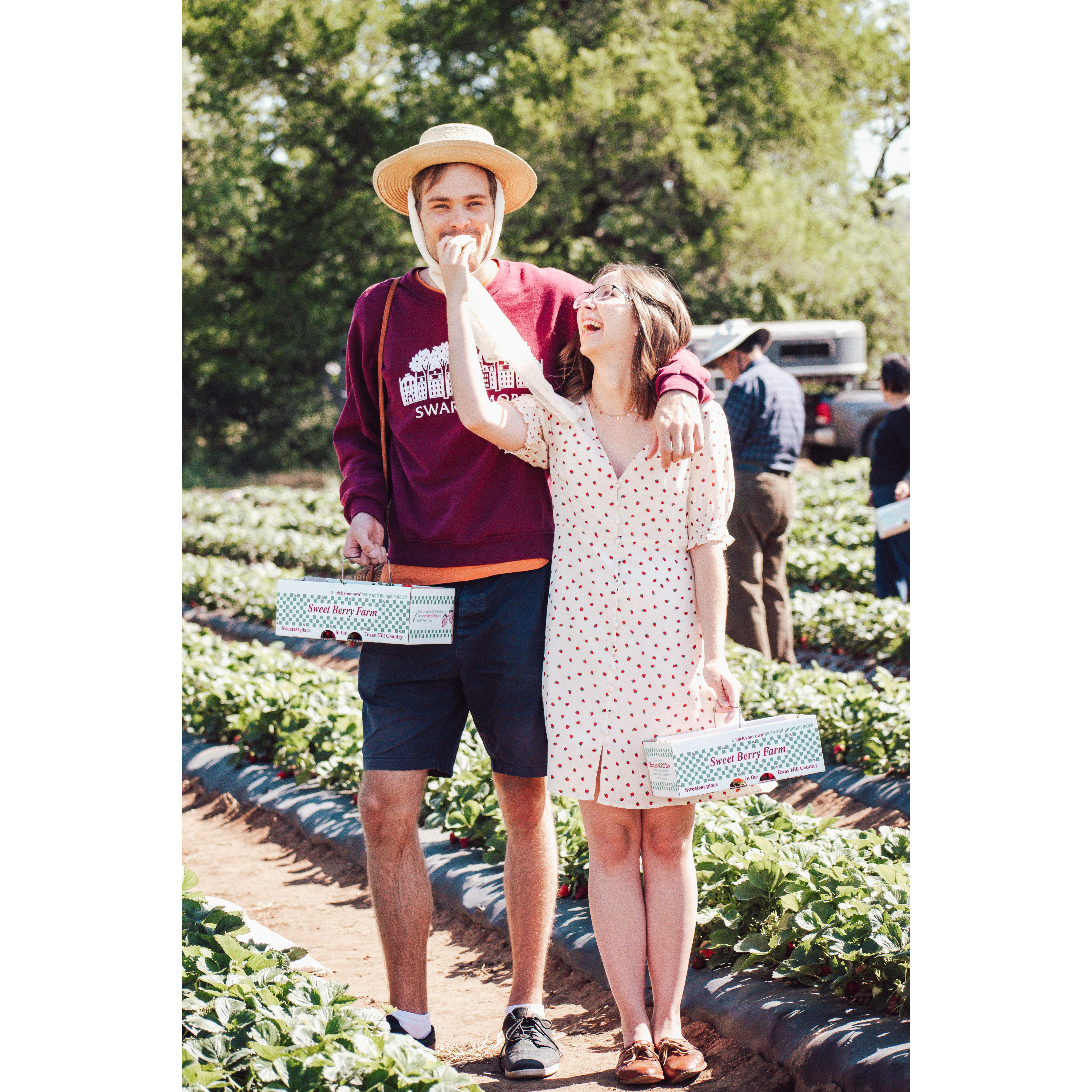 Henry really pulling off Chelsea's hat while strawberry picking.