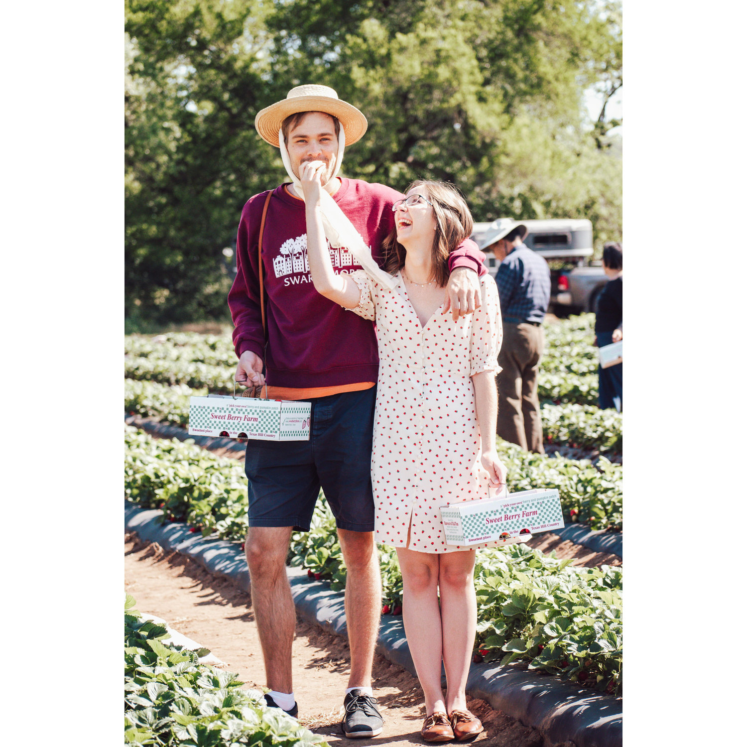 Henry really pulling off Chelsea's hat while strawberry picking.