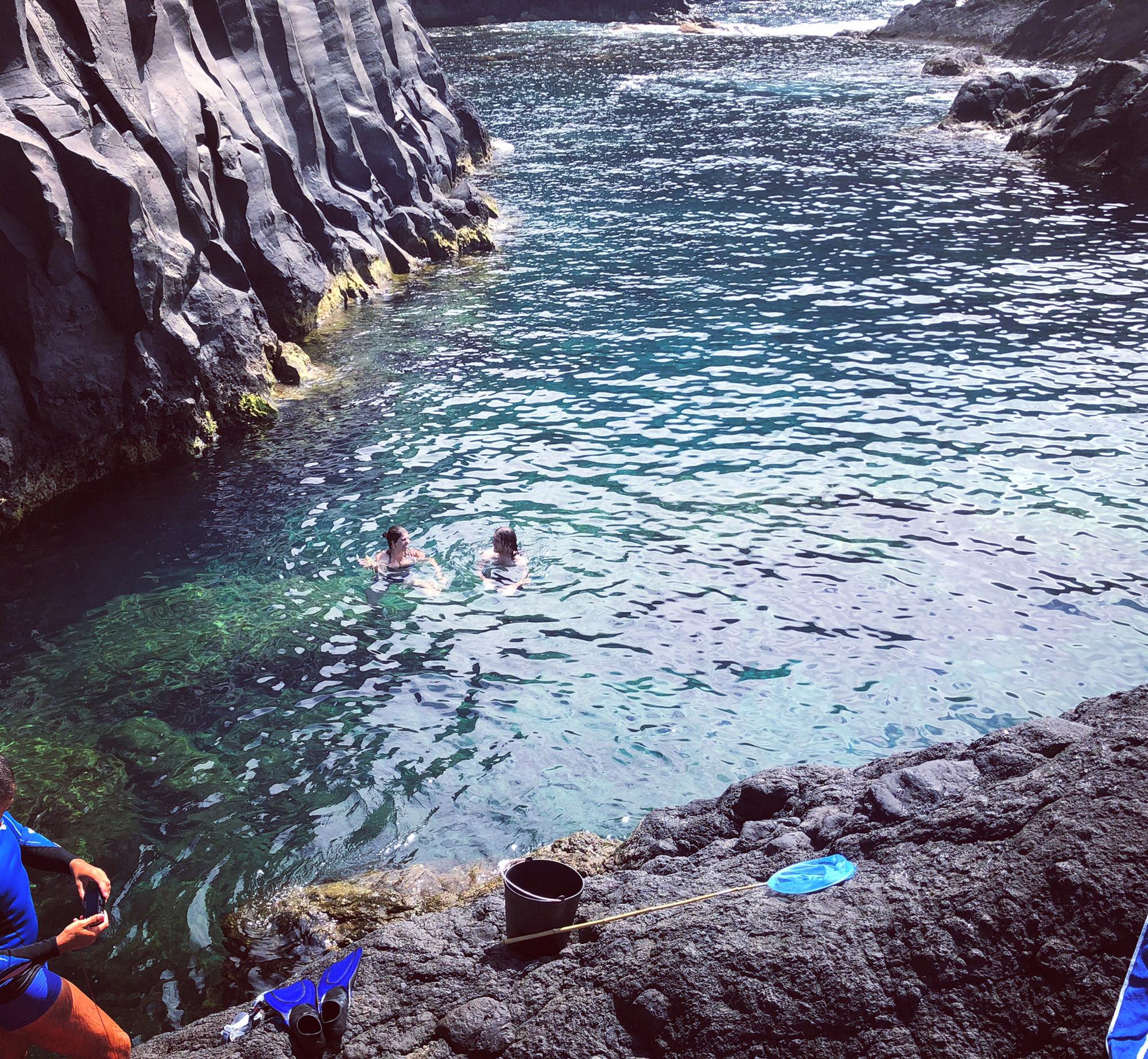 Marina and Sam, one of the groomsmen, taking a dip at one of the Velas on Sao Jorge Island