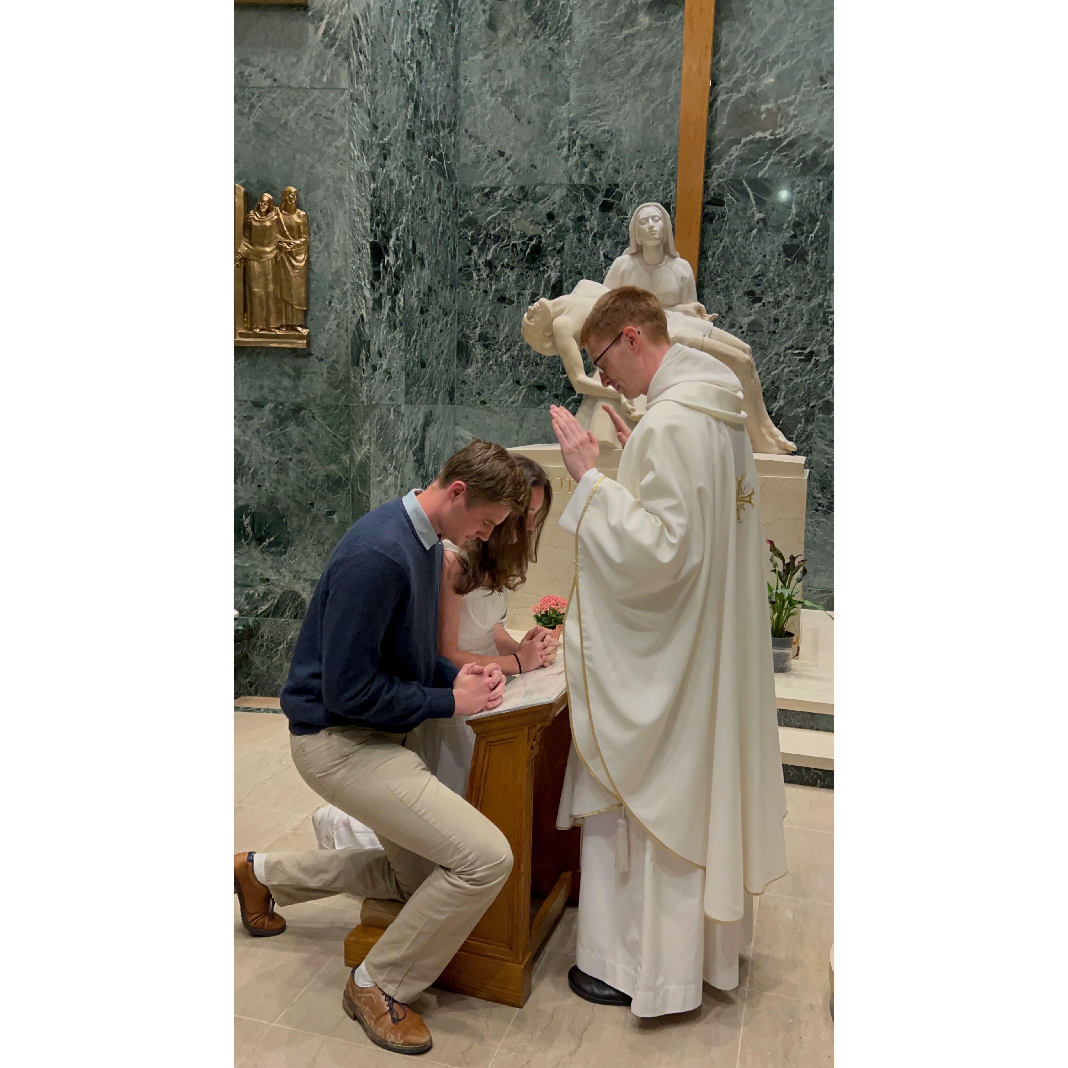 receiving a first blessing from newly ordained PC chaplain, Father Gregory