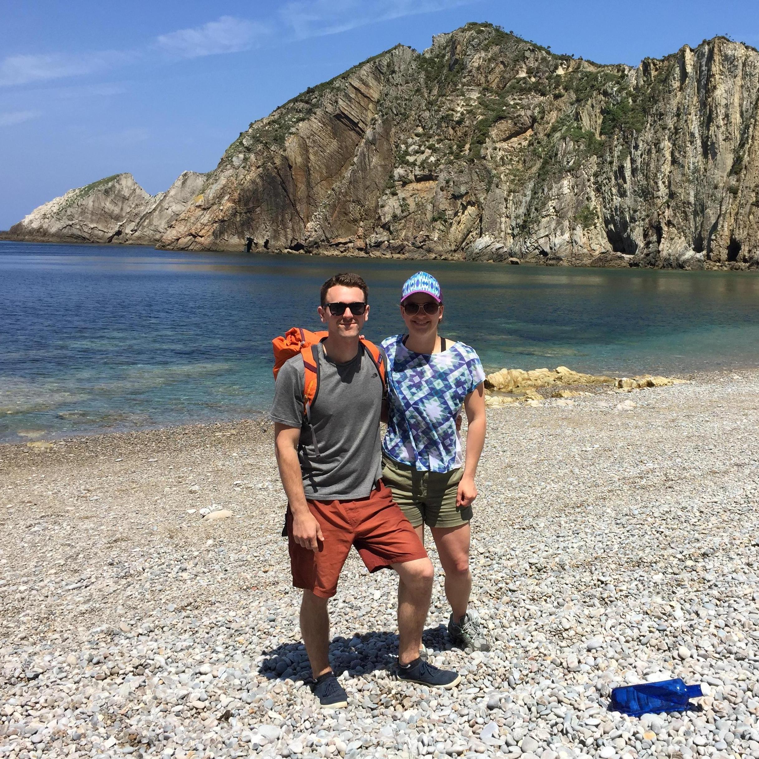 Enjoying a beautiful day at the beach on our trip through Spain at Playa del Silencio, Asturias