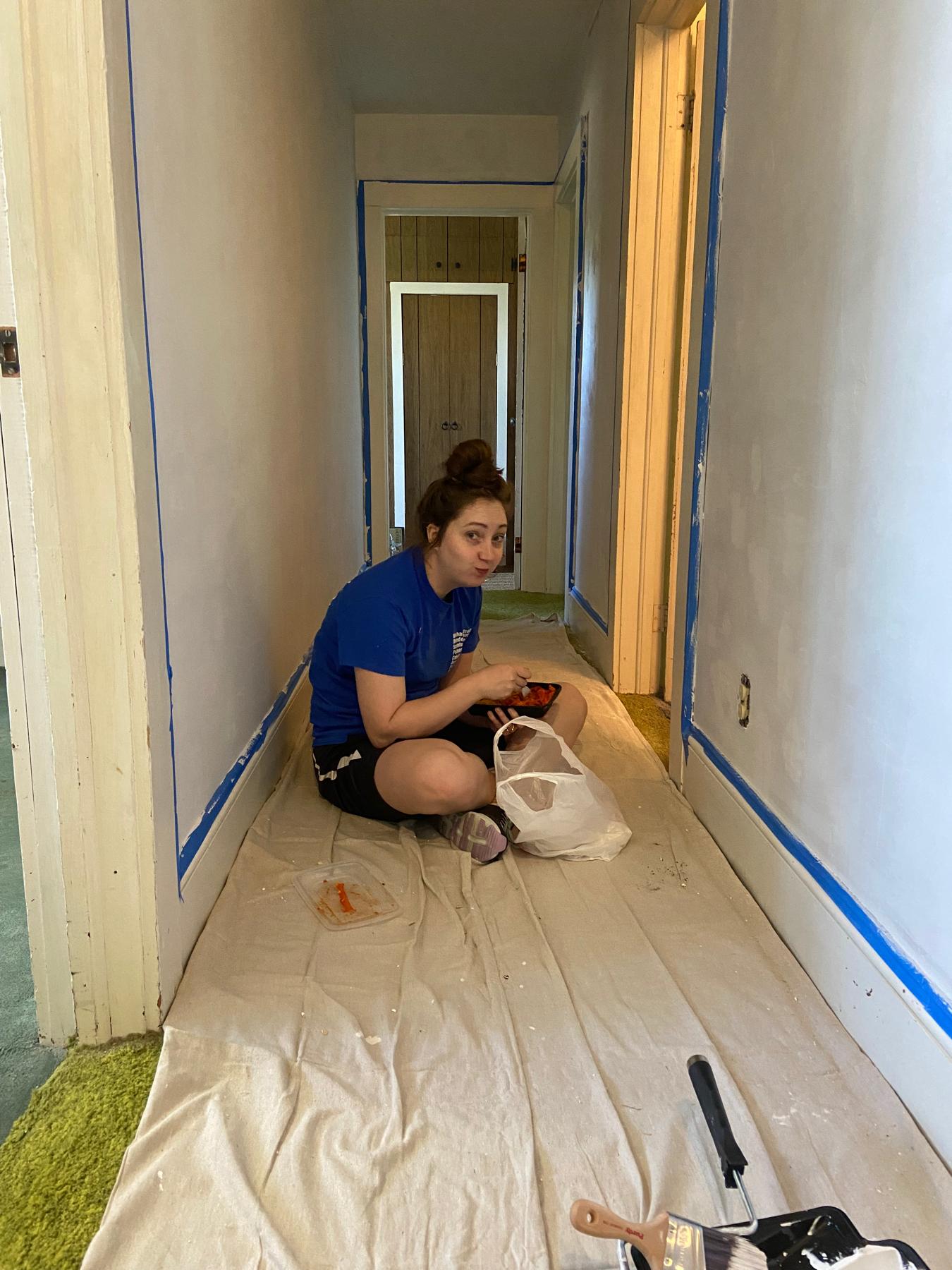 Darby eating Chinese food on the floor of our rental home while we remove wallpaper and paint the walls.
