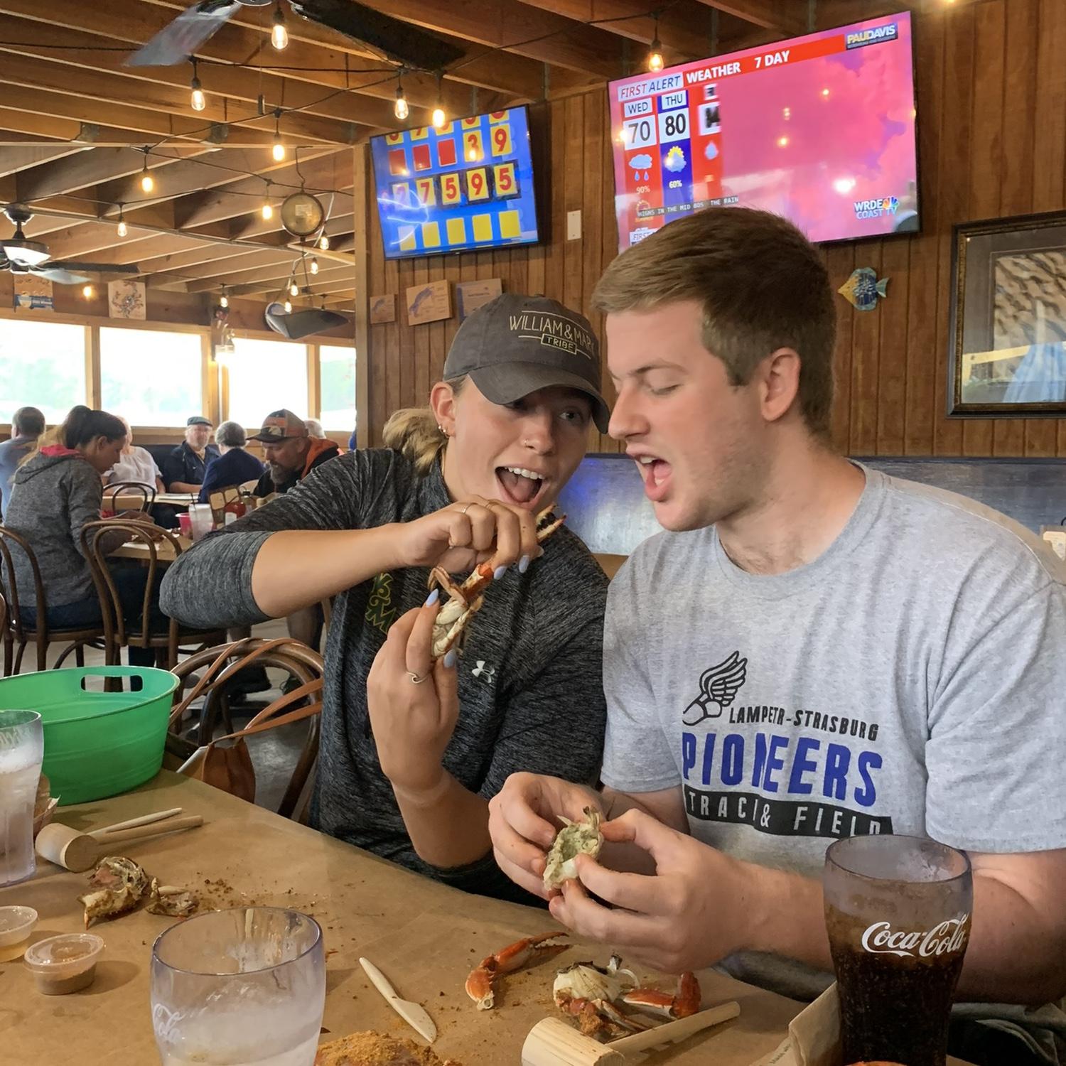 Jacob teaching Kristen how to eat crabs