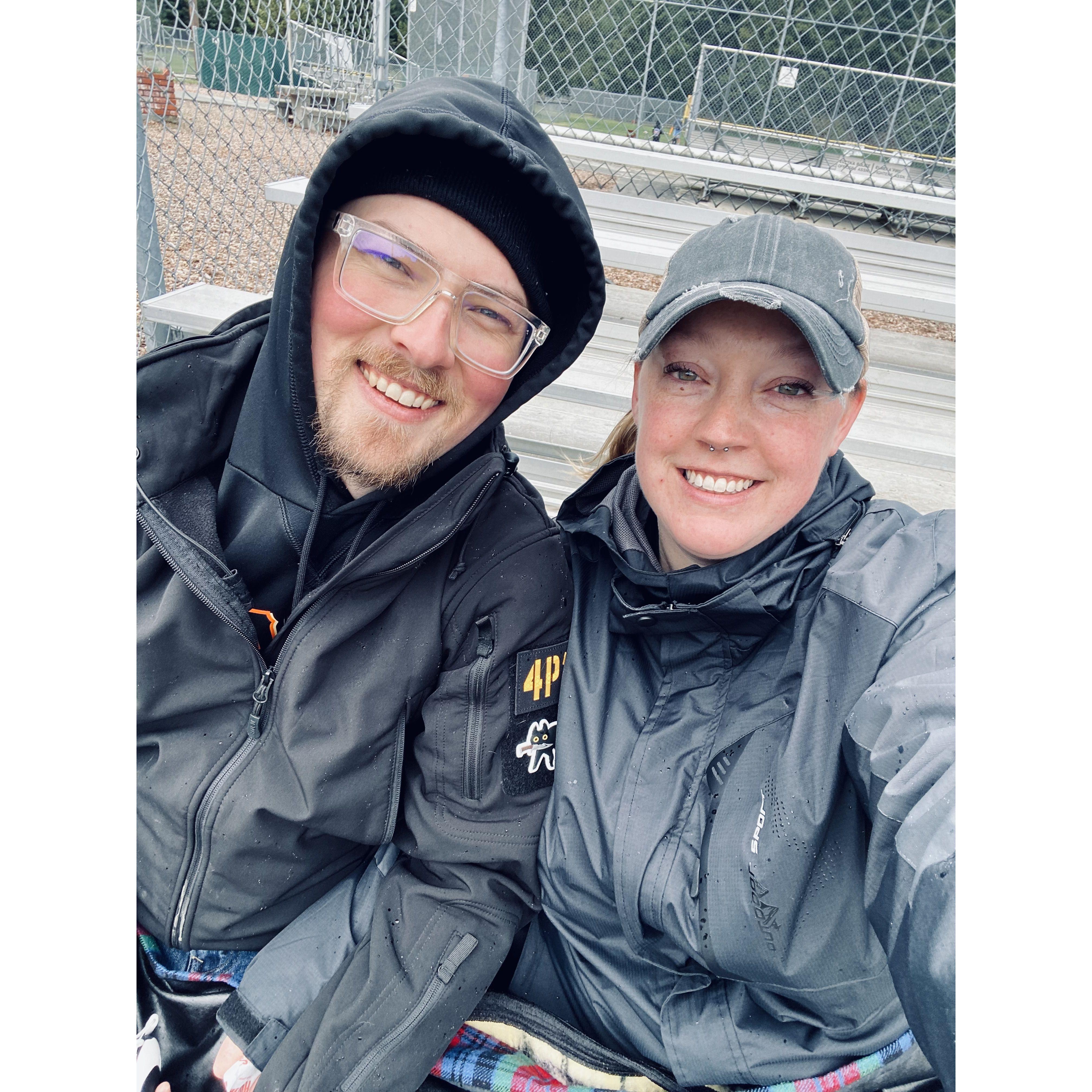 Getting rained on during our kiddo's baseball game.