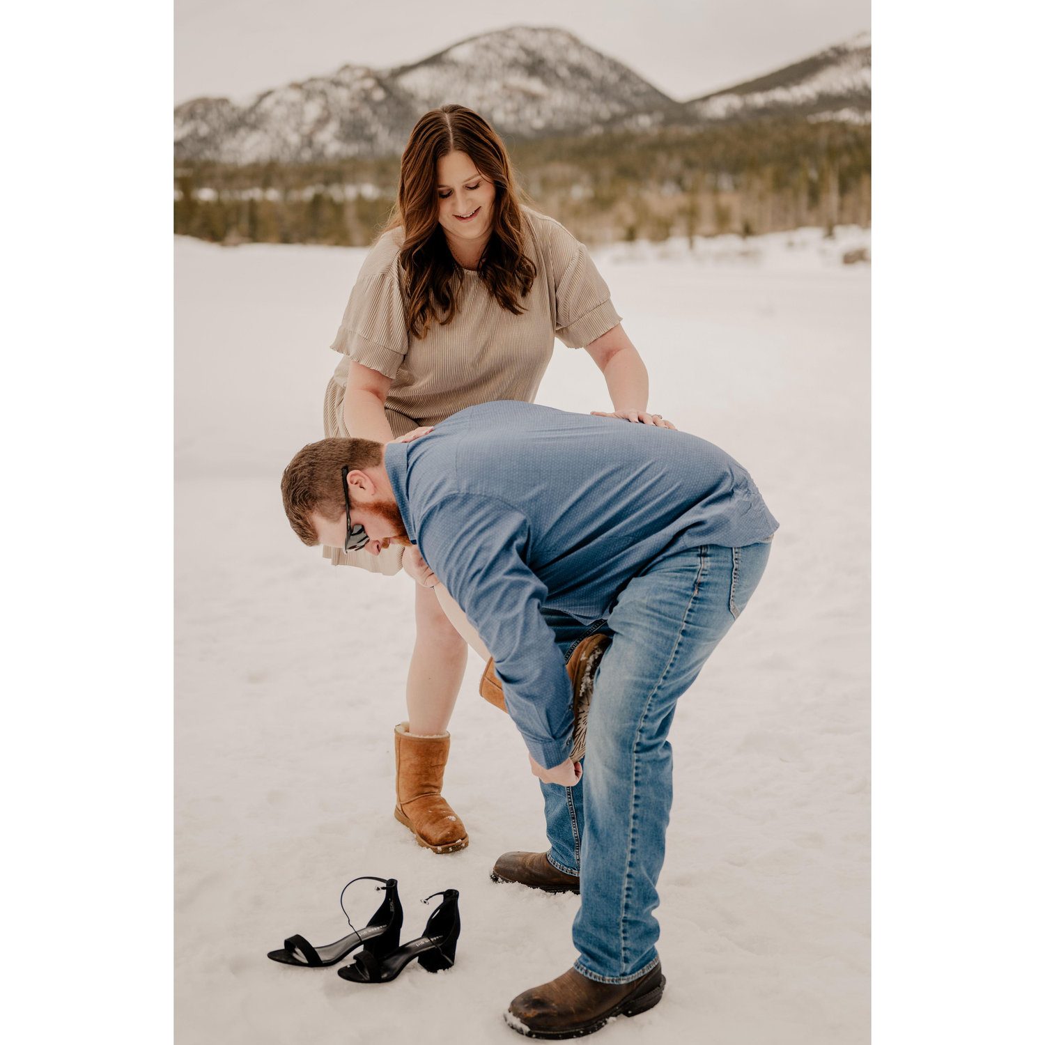 Amy was not walking in snow with heels on so between spots and locations during the shoot, Amy would wear boots to walk! Zach was there to help when the heels needed to come back on!