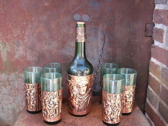 1960s French Carafe and Tumblers with rustic copper artwork of Fisherman and dancing couples. Retro green bottle decanter and 6 glasses set.